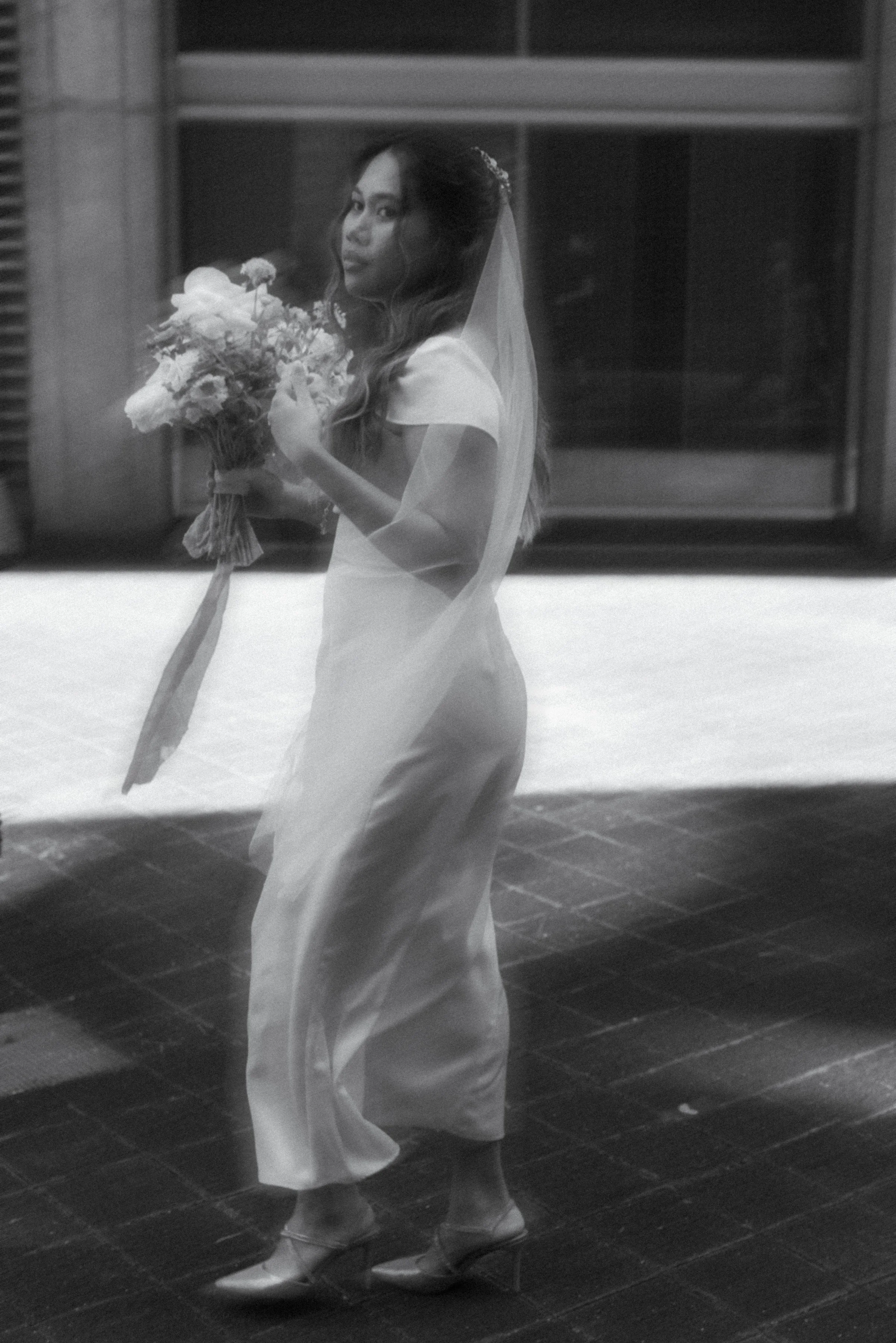 Black and white editorial portrait of a bride at Toronto City Hall on her elopement day