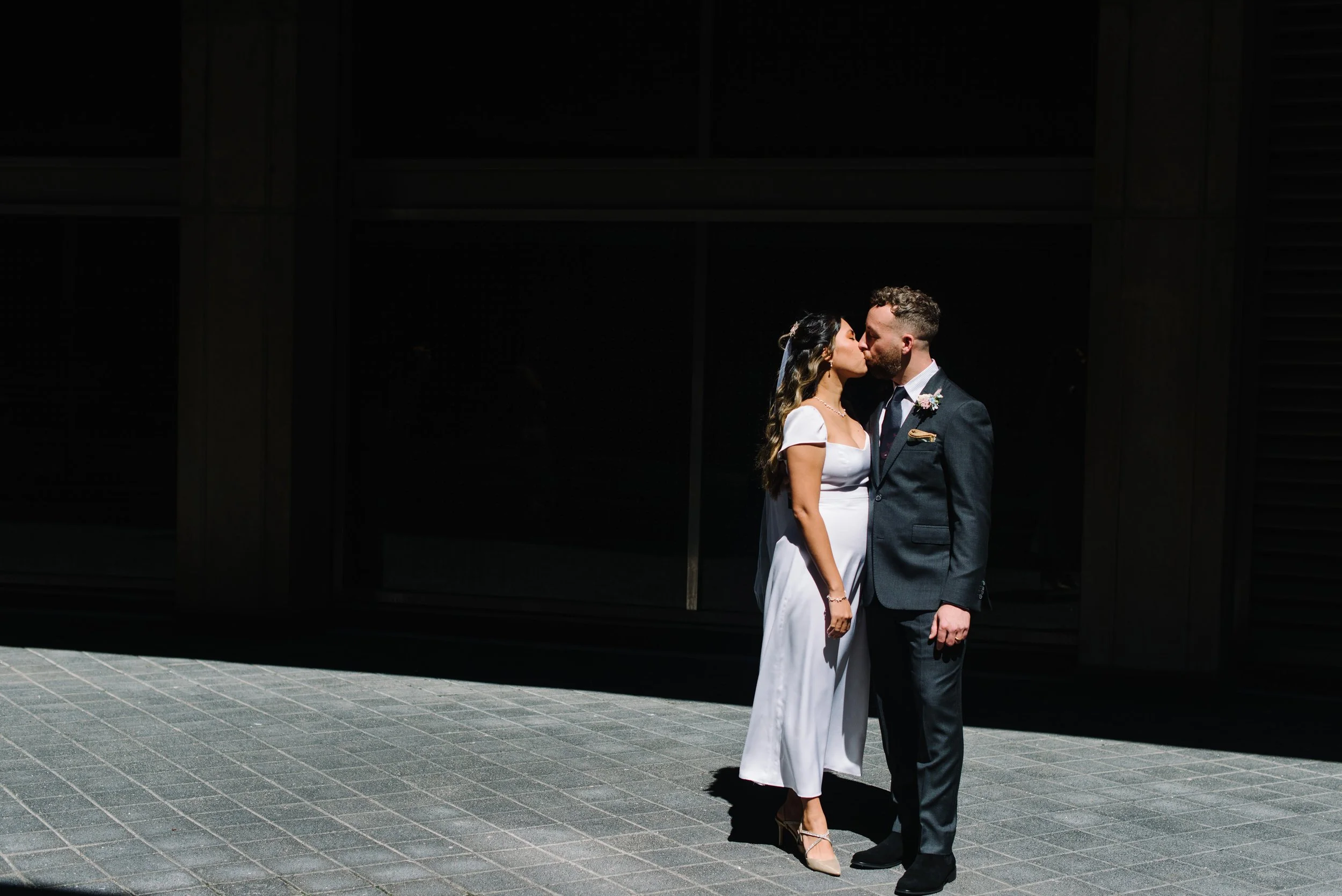 Dramatic editorial portrait of a bride and groom at Toronto City Hall during their intimate elopement