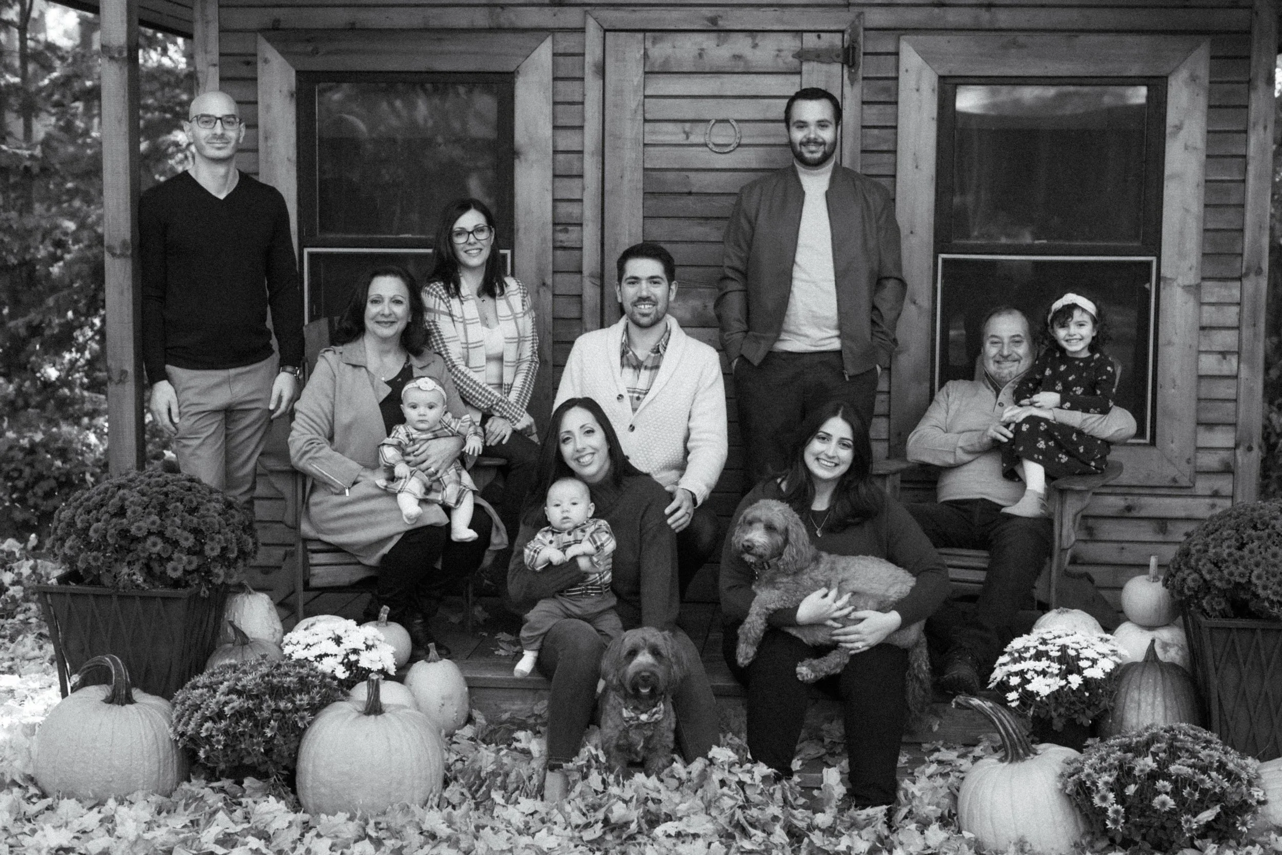 Black and white portrait of a multi-generational extended family in a Mississauga backyard