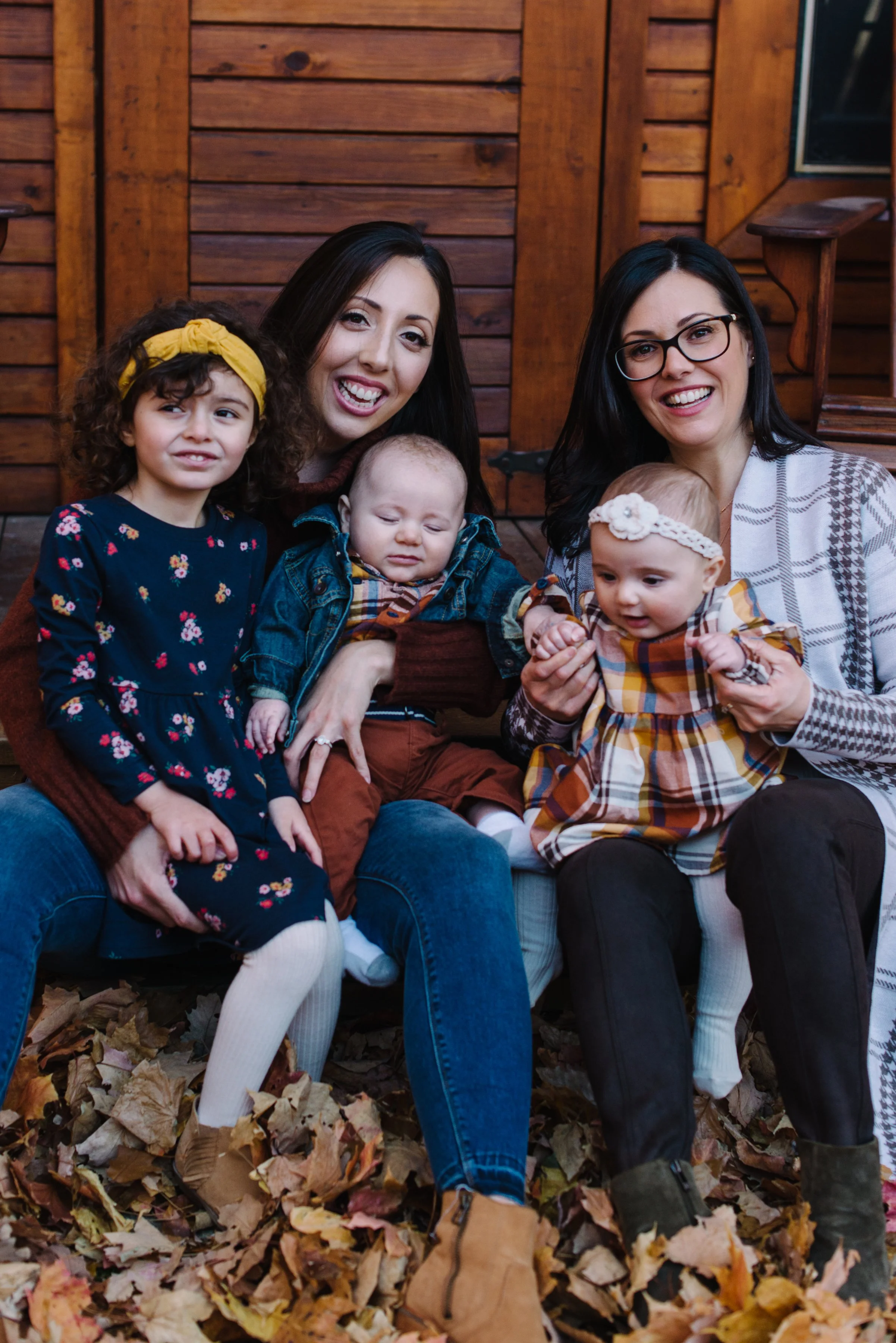 Two sisters with their children photographed during a fall extended family session near Toronto