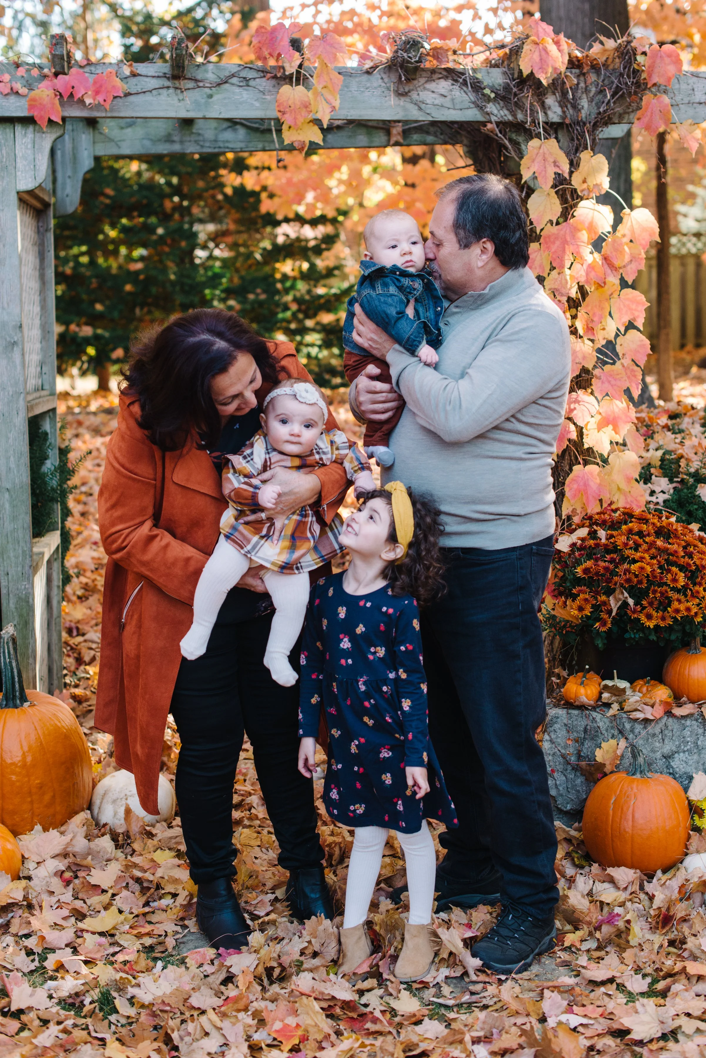 Grandparents with their grandchildren during a multi-generational fall family session in Mississauga
