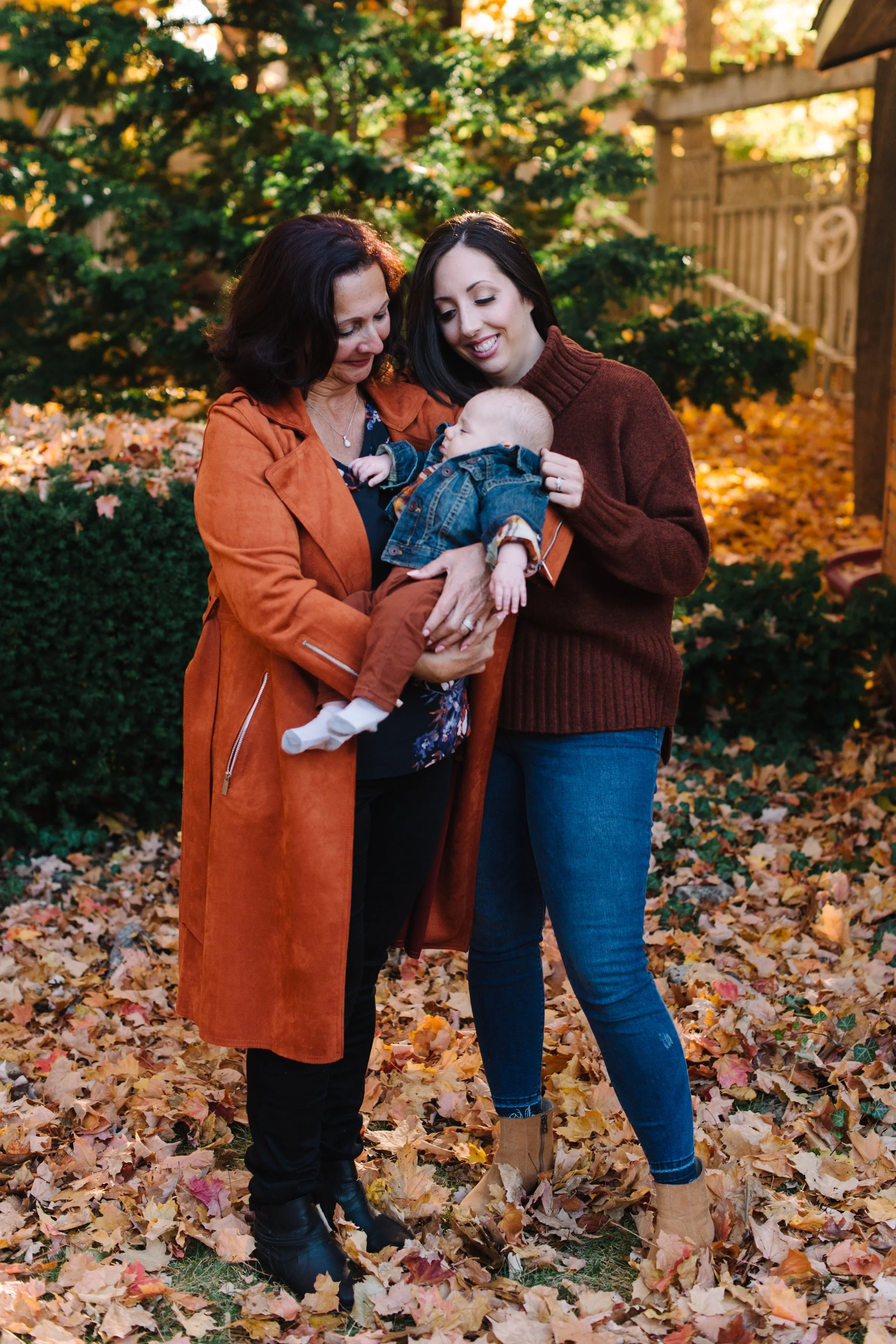 Three generations — grandmother, mother, and baby — photographed during a fall family session near Toronto