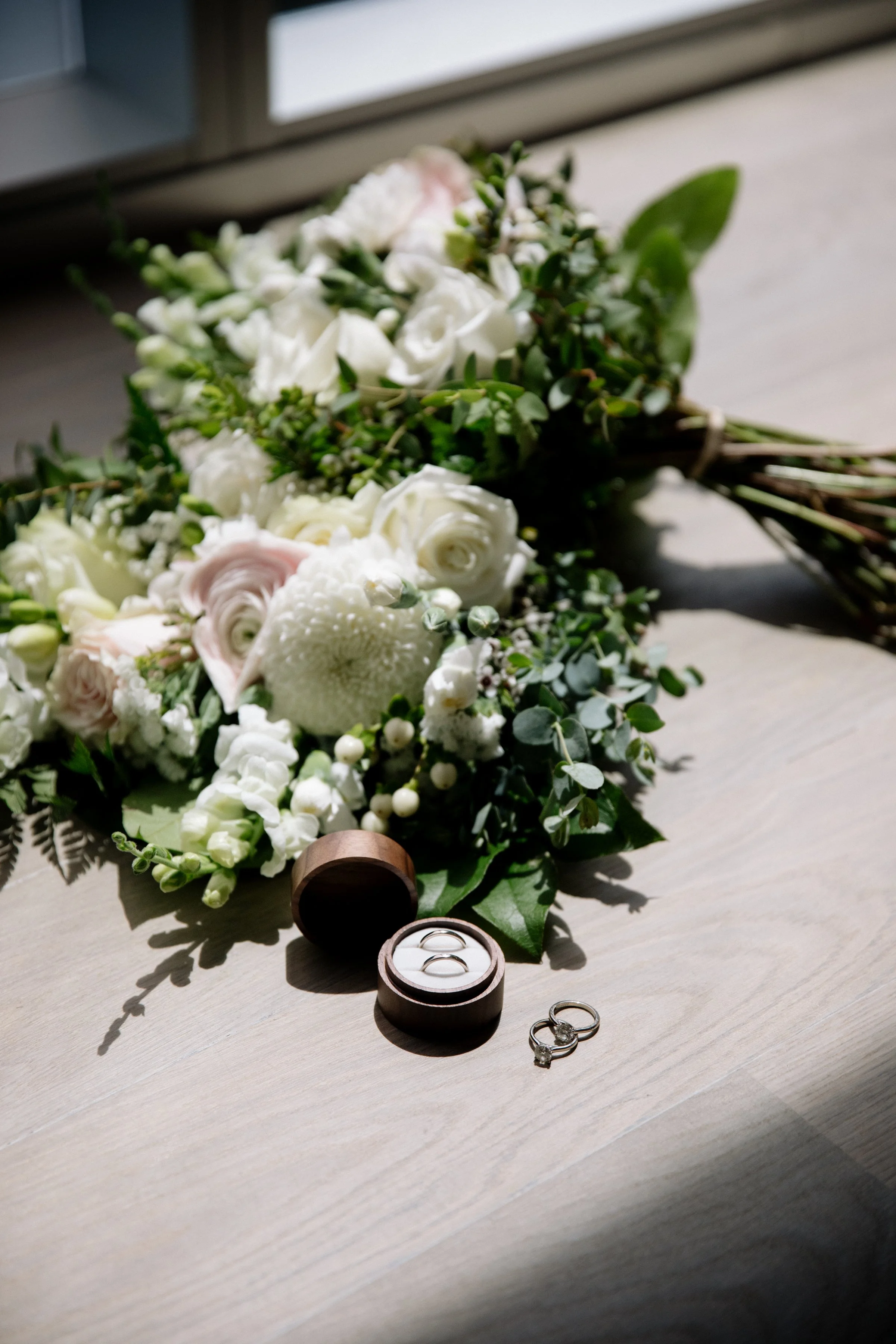 Detail photo of a bridal bouquet and wedding rings at a chic same-sex elopement in Toronto