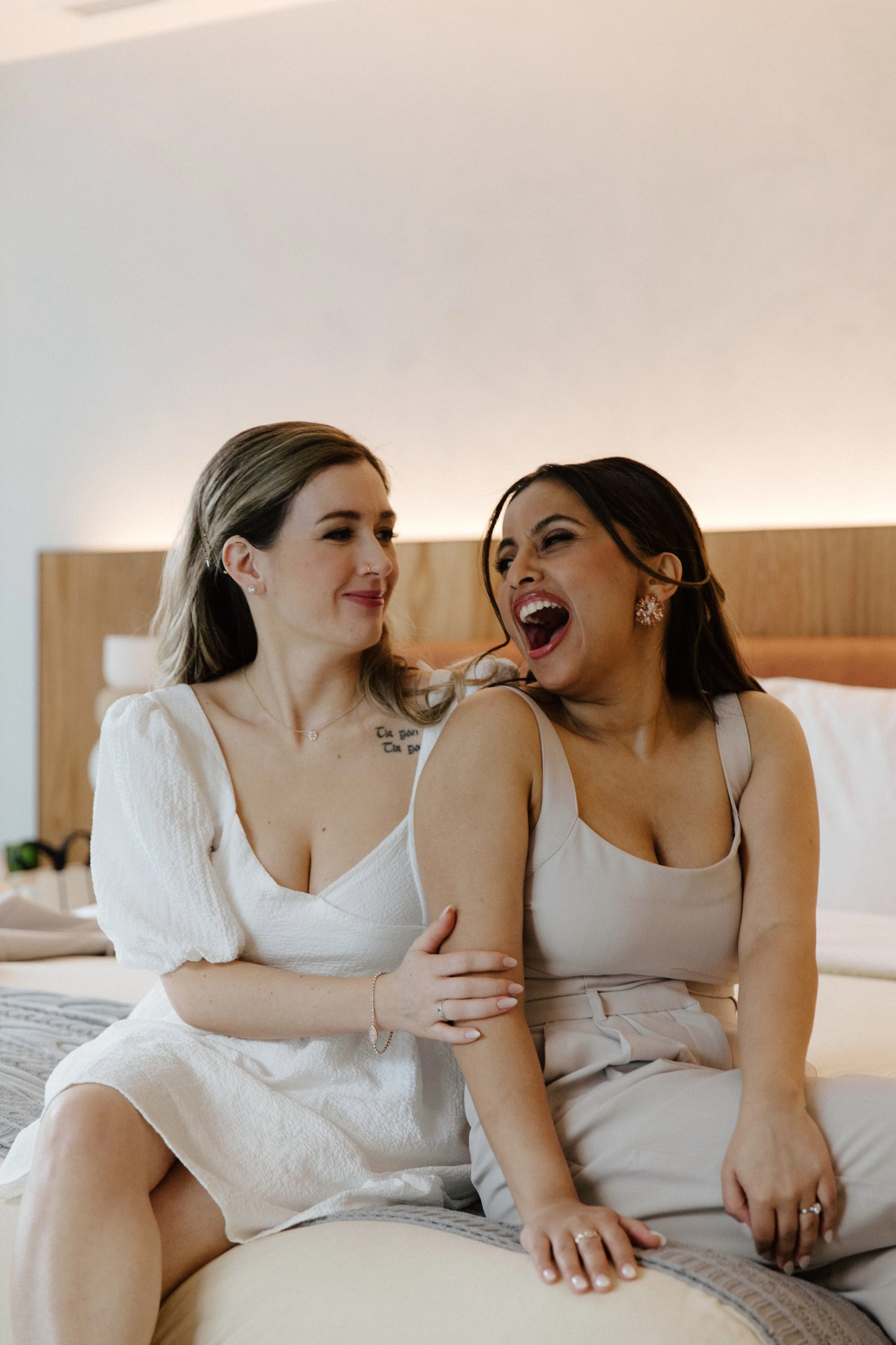 Two brides getting ready together at 1 Hotel Toronto before their same-sex city hall elopement