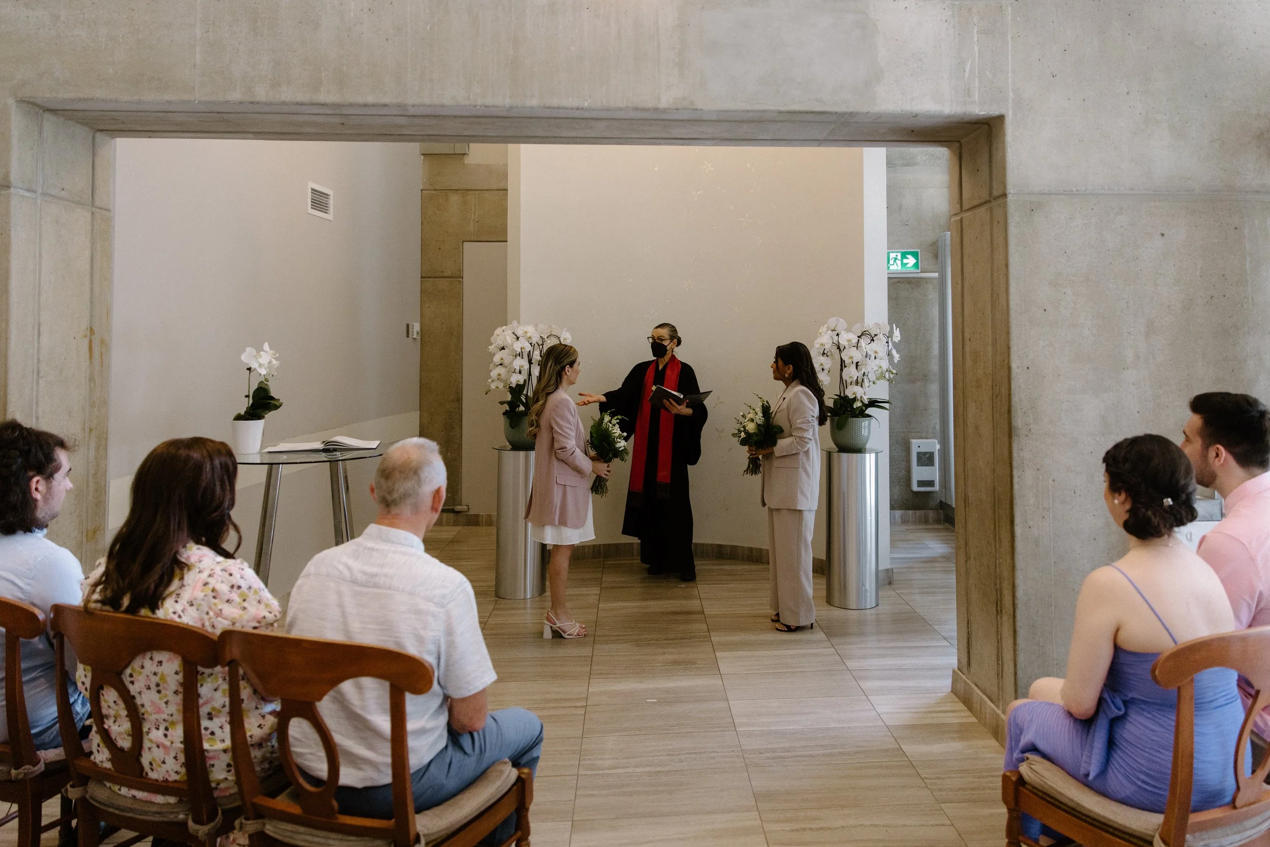 Documentary style photo of a same-sex wedding ceremony taking place at Toronto City Hall