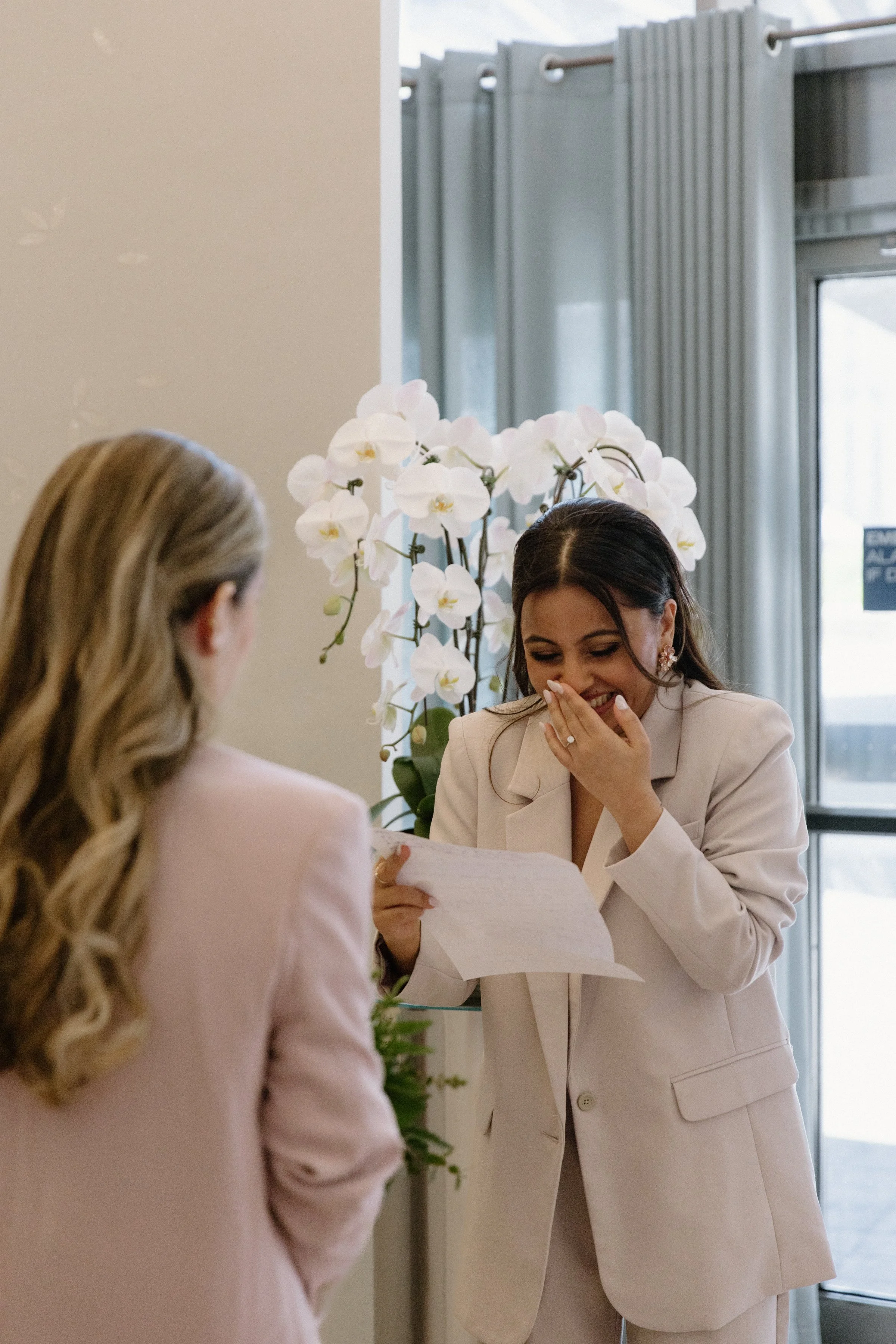 Documentary photo of a bride reading her wedding vows during a same-sex elopement at Toronto City Hall