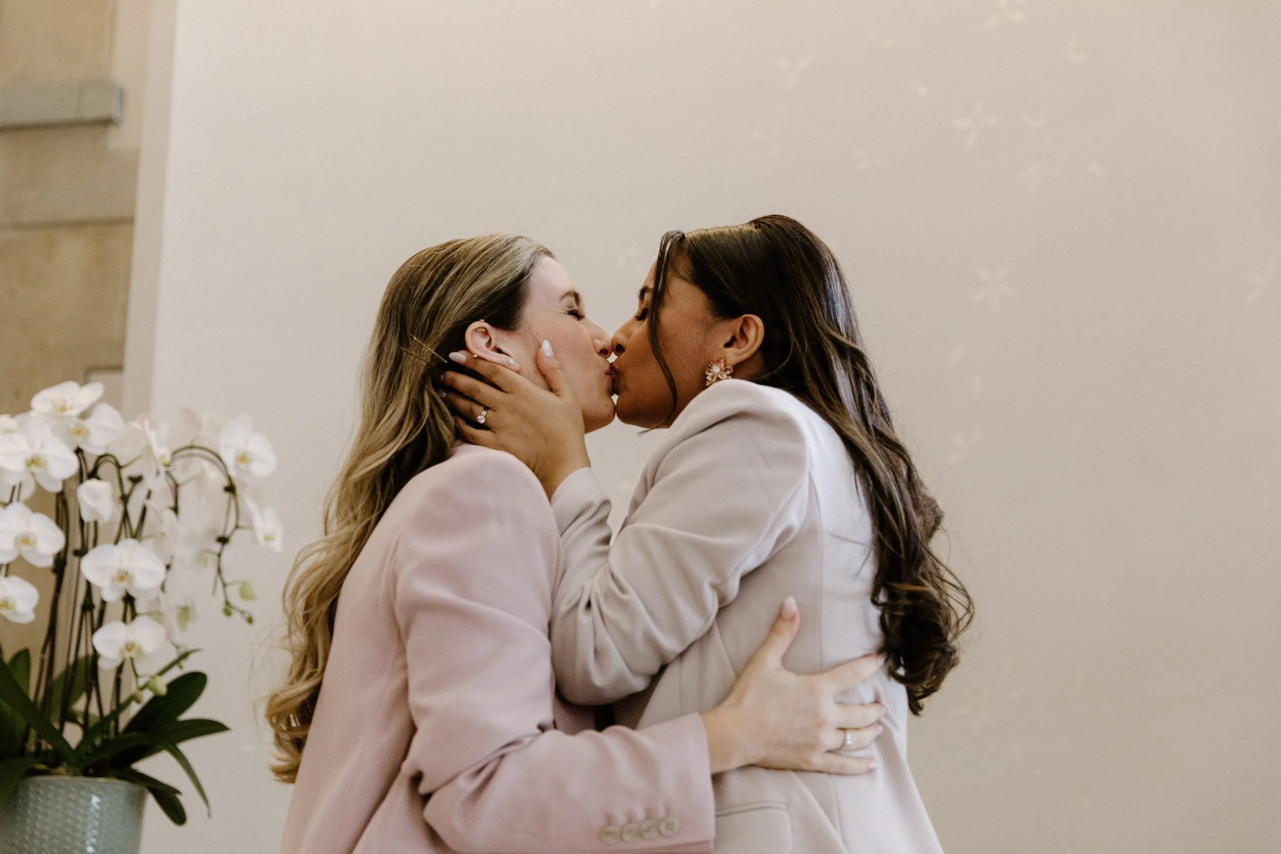 Two brides sharing their first kiss as a married couple at their Toronto City Hall elopement