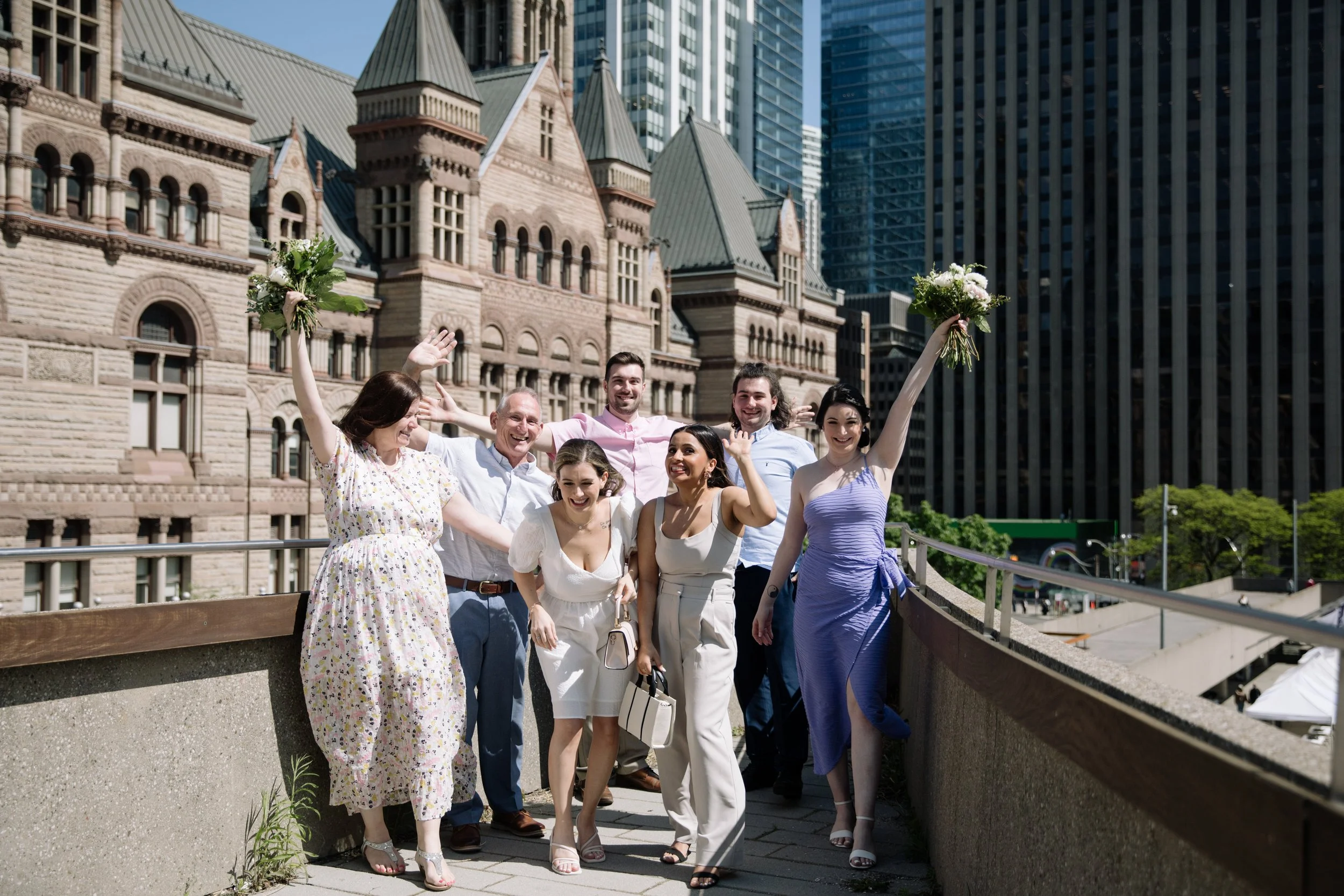 Formal family portrait in front of Old City Hall in downtown Toronto after a same-sex elopement