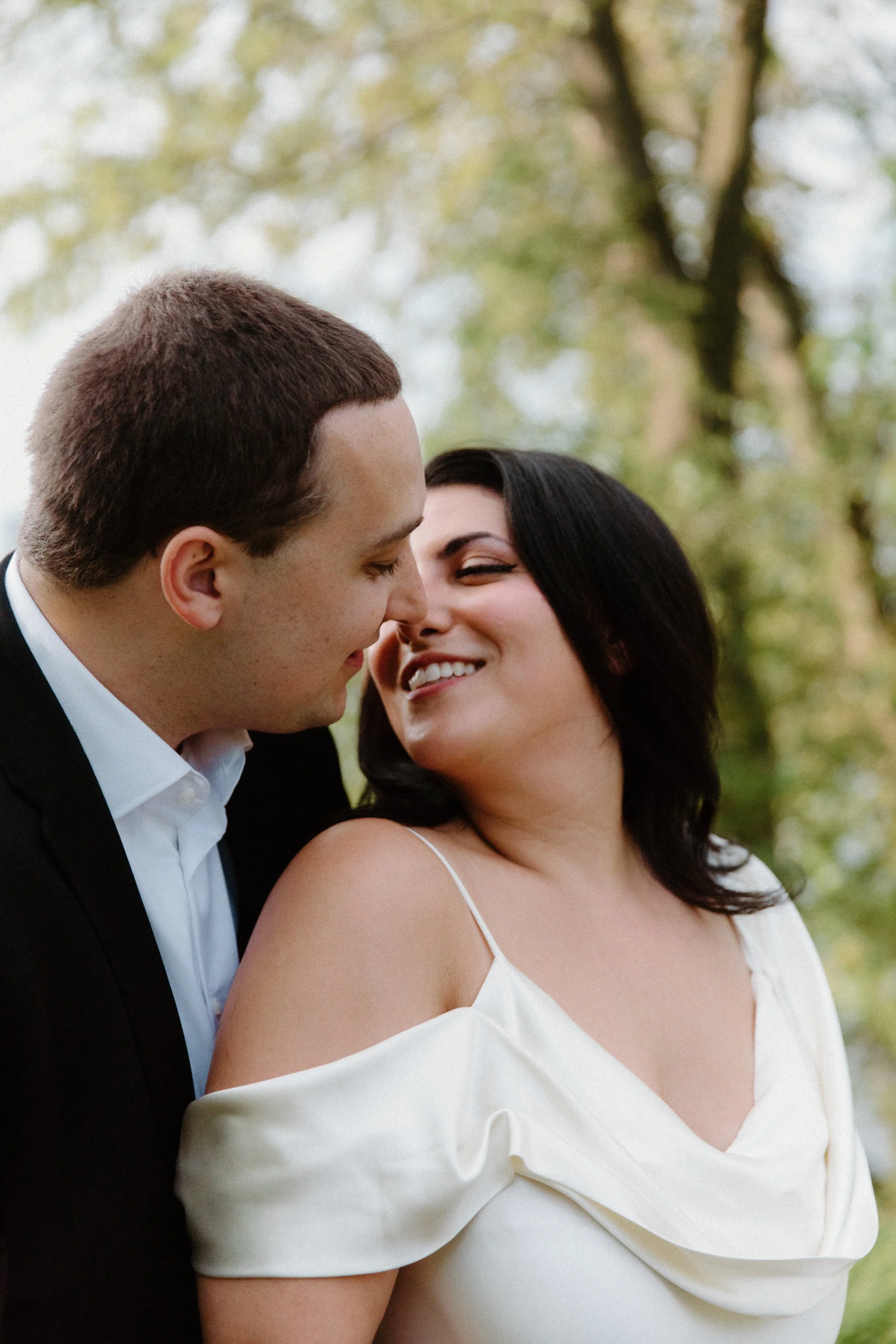 Romantic almost-kiss portrait of an engaged couple at Centre Island, Toronto