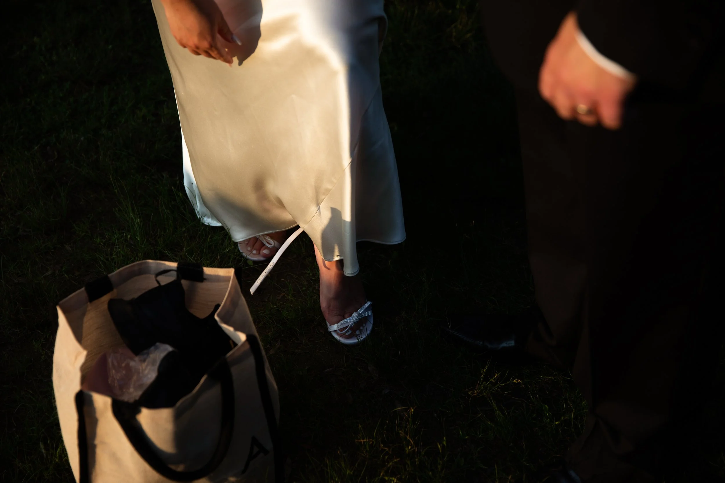 Ground-level detail of a Reformation wedding dress during a portrait session on the Toronto Islands