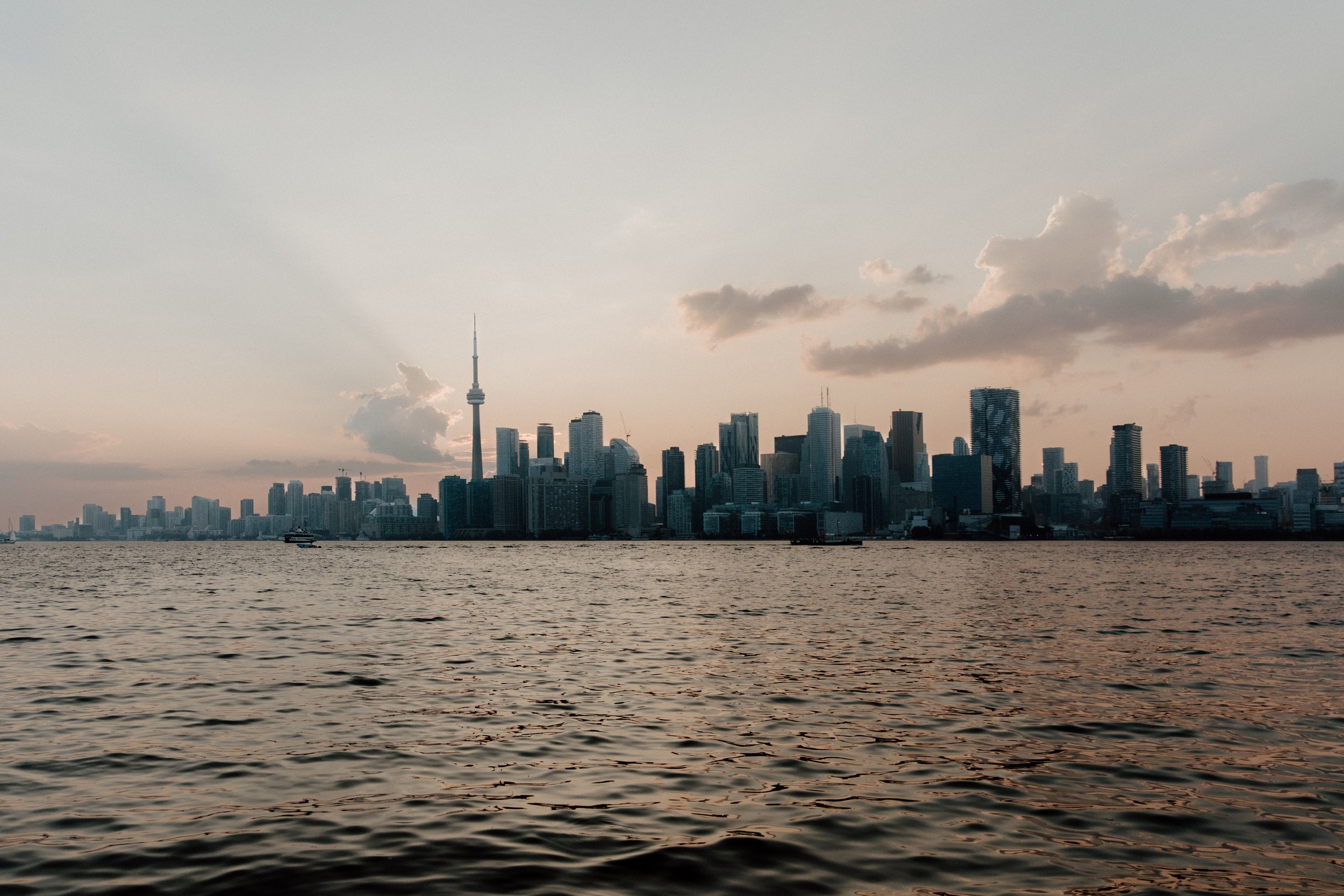 Panoramic view of the Toronto skyline over Lake Ontario at sunset from the Toronto Islands