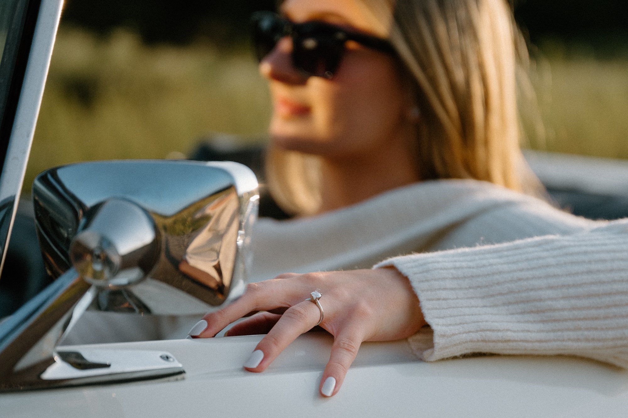 Bride to be in the driver's seat of a vintage Mustang with her engagement ring in focus, Kawartha region Ontario
