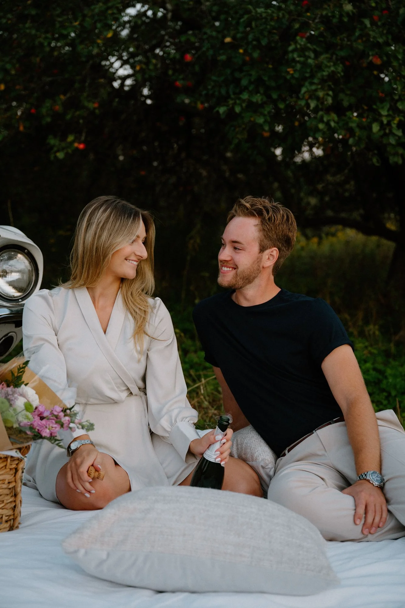 Styled engagement session with a picnic and vintage Mustang in a field near Peterborough, Ontario