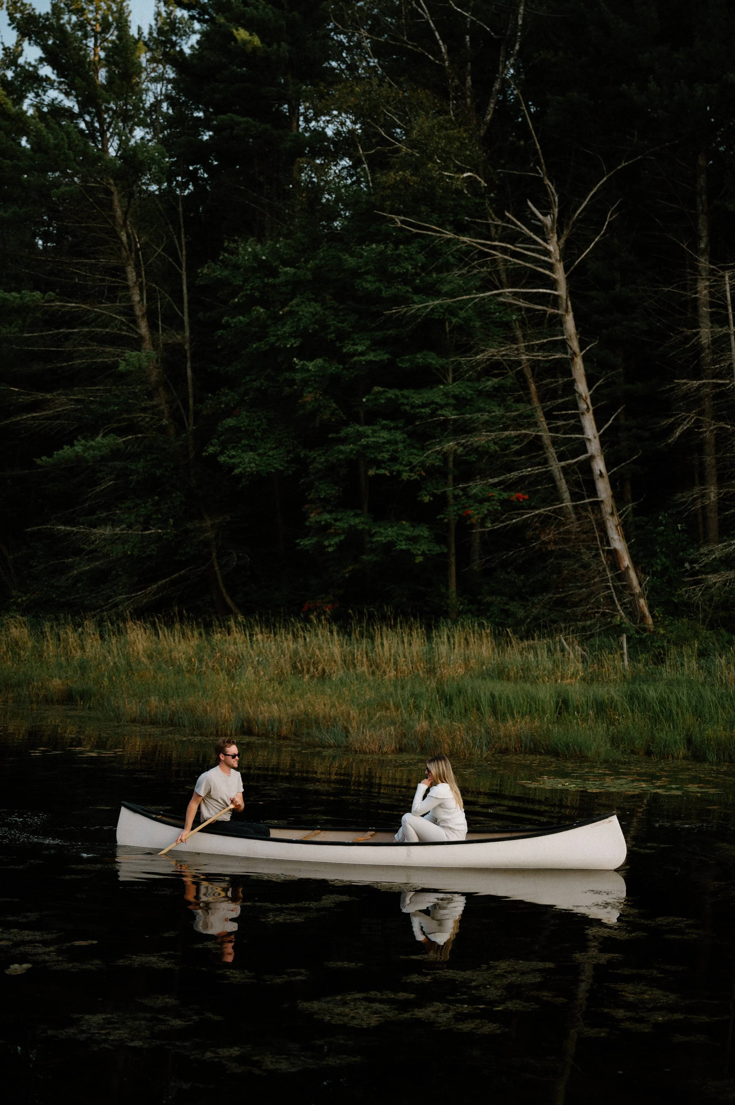 Cottage engagement session in Muskoka with a couple in a canoe