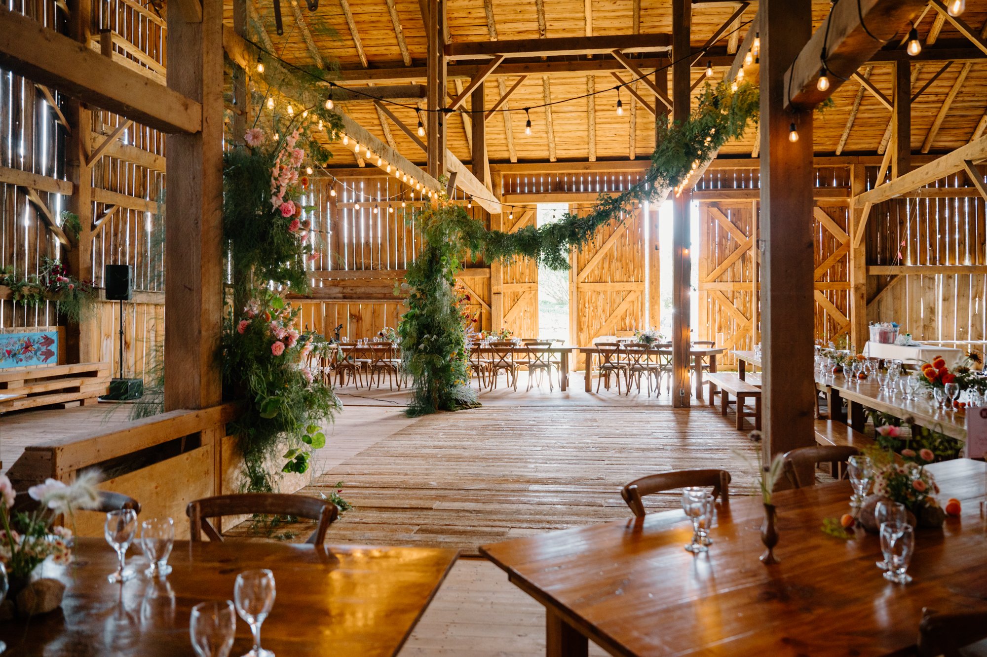 Decorated barn interior during an intimate farm wedding reception near Orangeville, Ontario