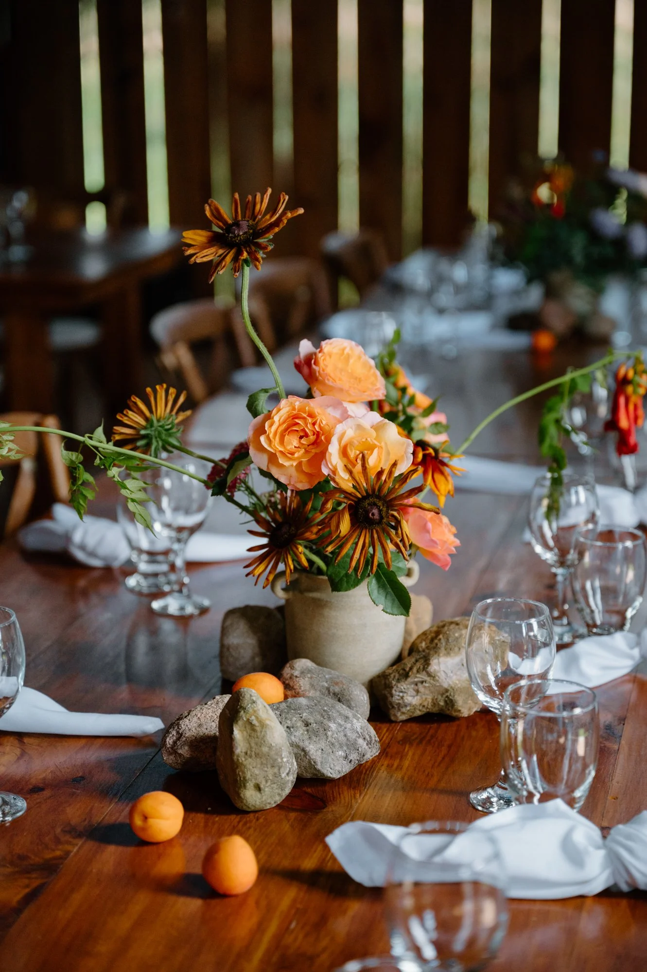 Rustic yet chic styled dinner table with floral detail at an intimate farm wedding near Orangeville, Ontario