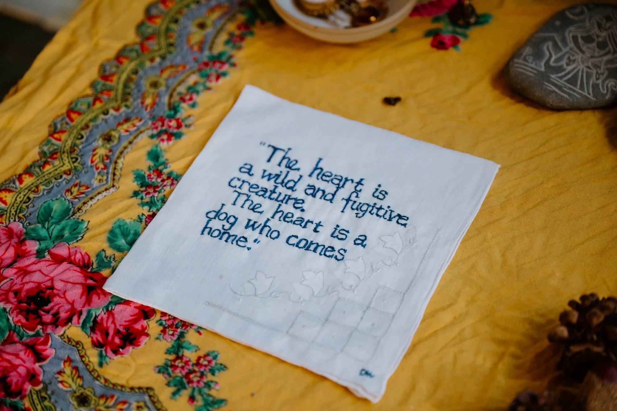 Detail photo of a hand sewn napkin featuring a love quote at a queer farm wedding near Orangeville, Ontario