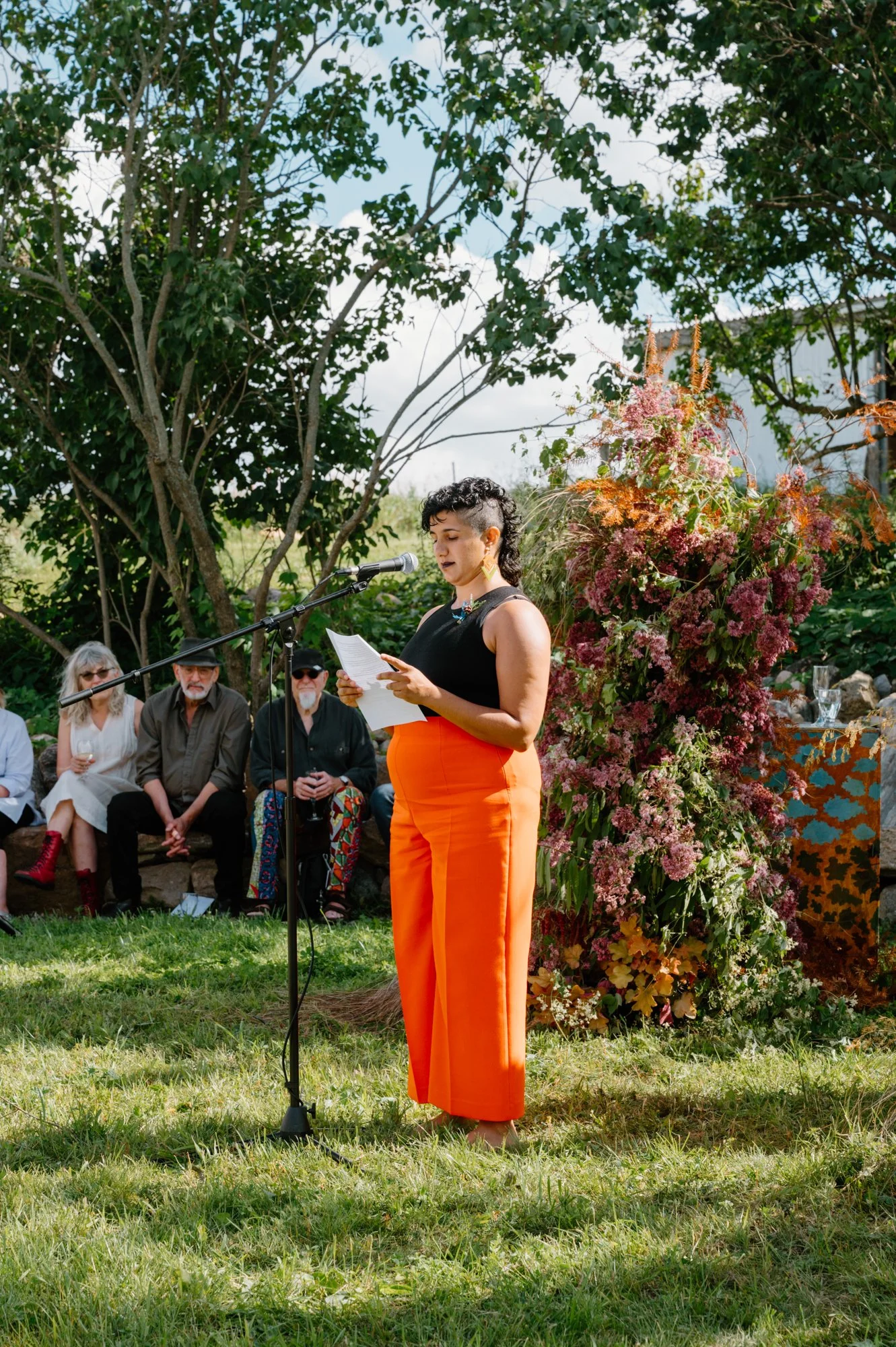 Guest sharing a heartfelt speech during an LGBTQ+ wedding ceremony at a farm near Orangeville, Ontario