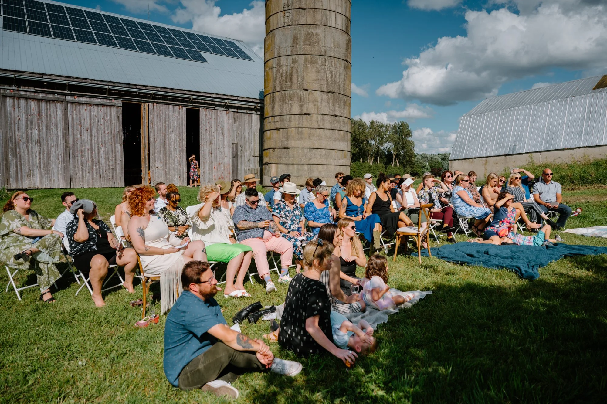 Guests seated at an outdoor wedding ceremony at a farm near Orangeville, Ontario