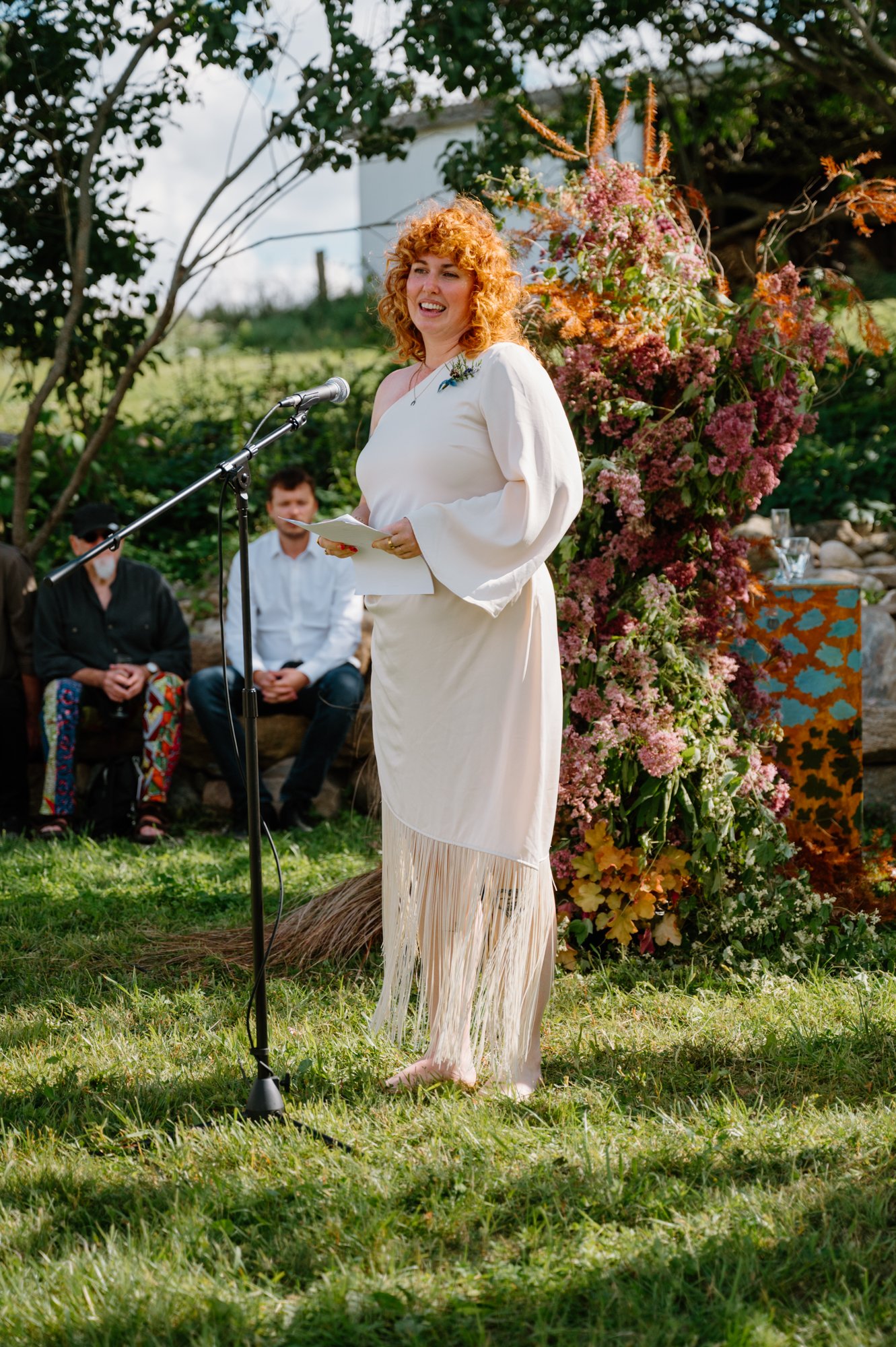 Candid photo of a guest delivering an emotional speech at an intimate queer wedding ceremony in Ontario