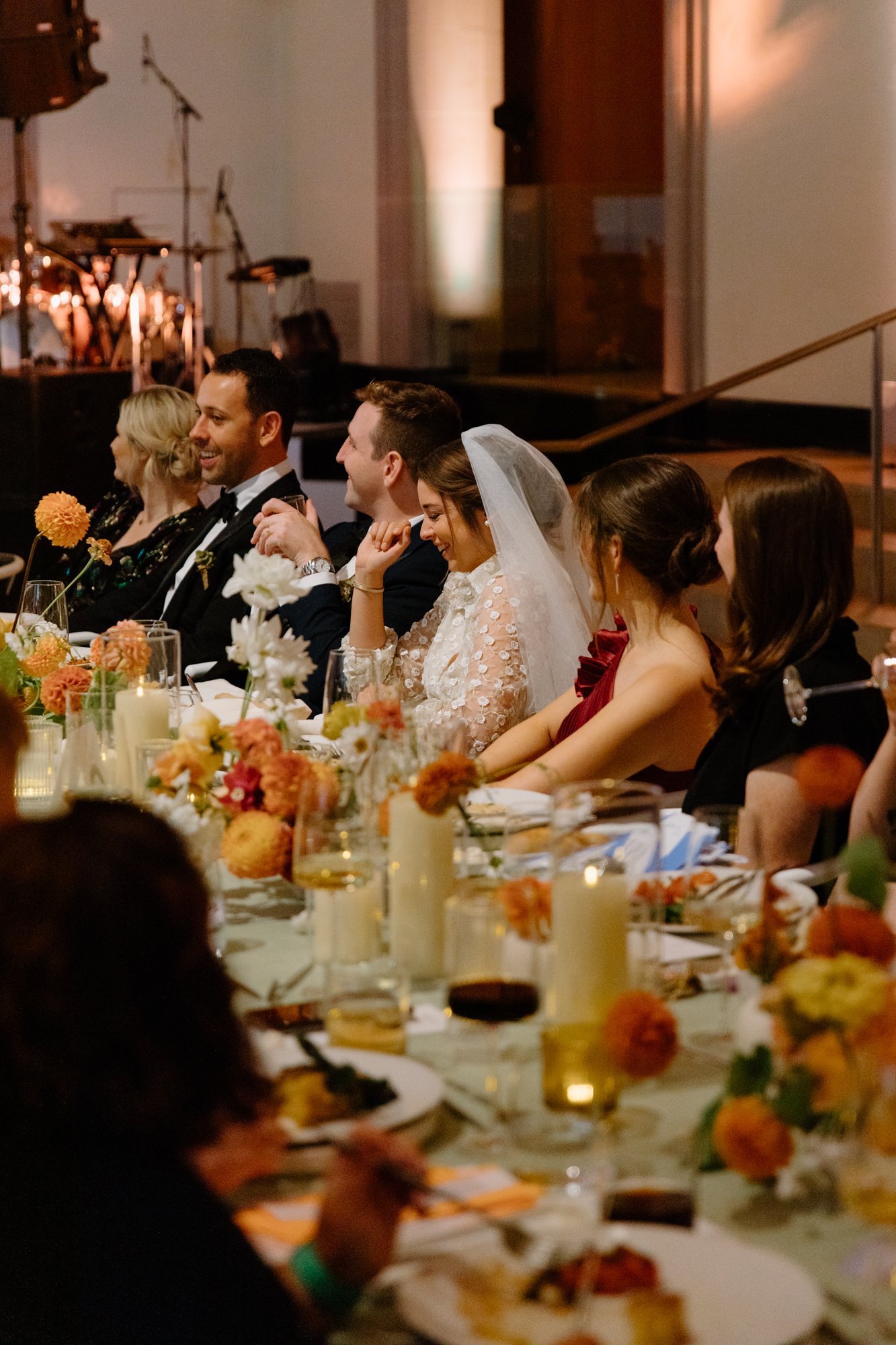 Couple sharing candid moments during their AGO wedding reception