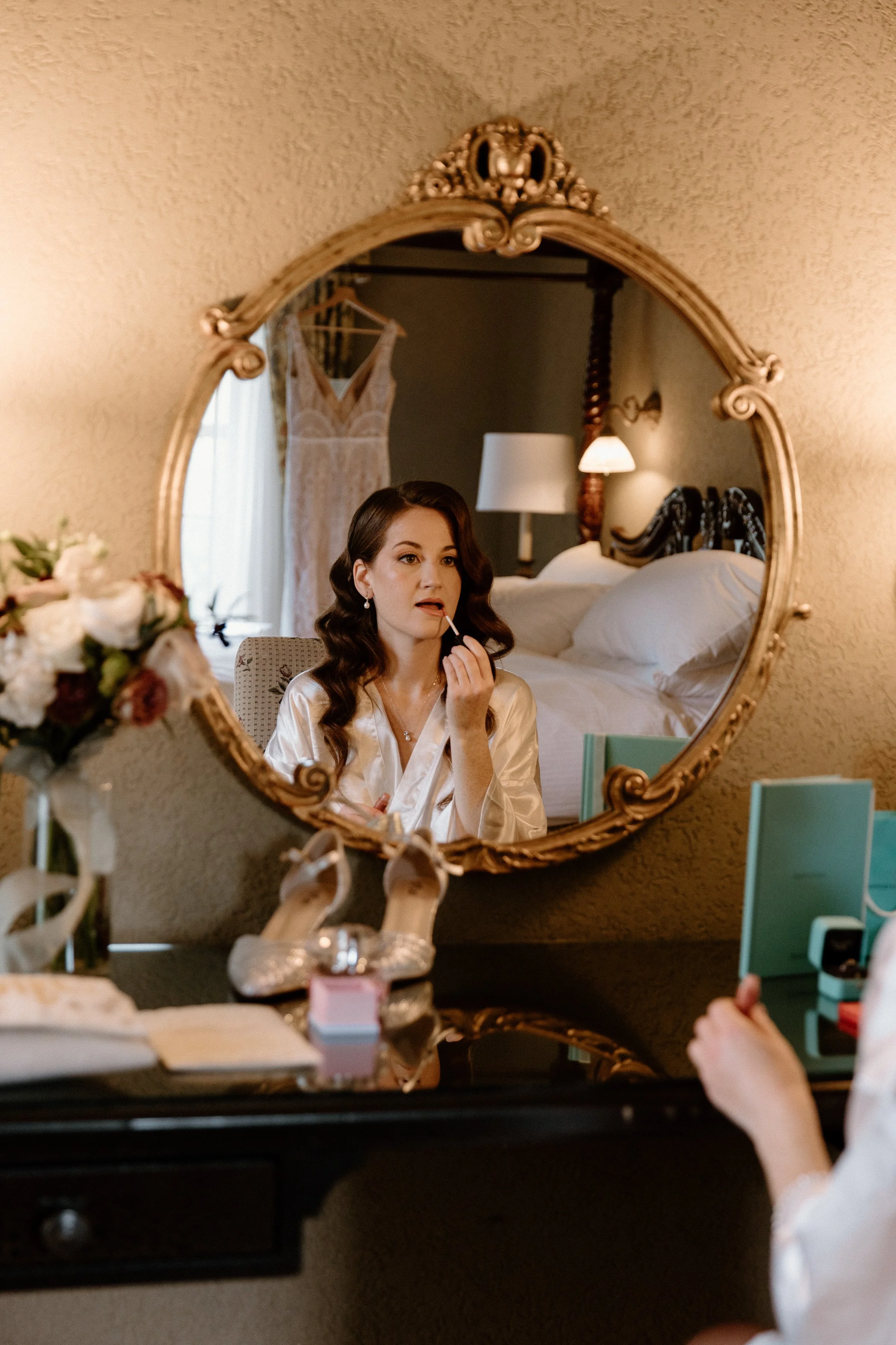 Portrait of a bride getting ready captured as a reflection in a mirror on her Toronto wedding day