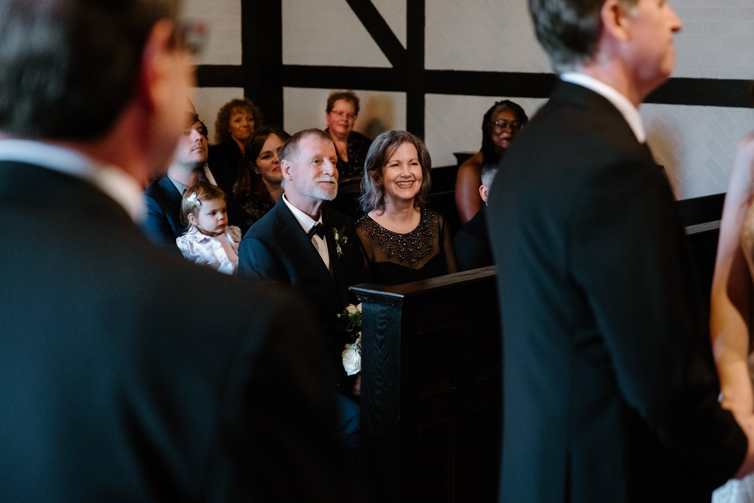 Candid photo of parents smiling with joy during a Toronto wedding ceremony