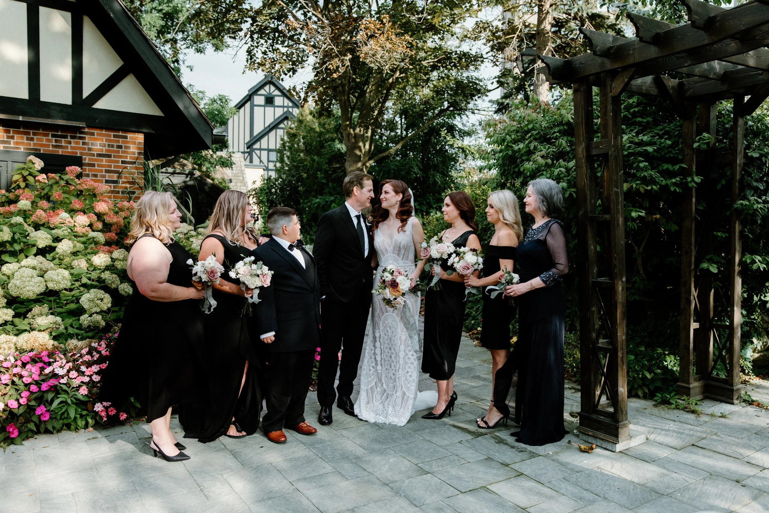 Formal group portrait of a bridal party in a garden during a Toronto wedding