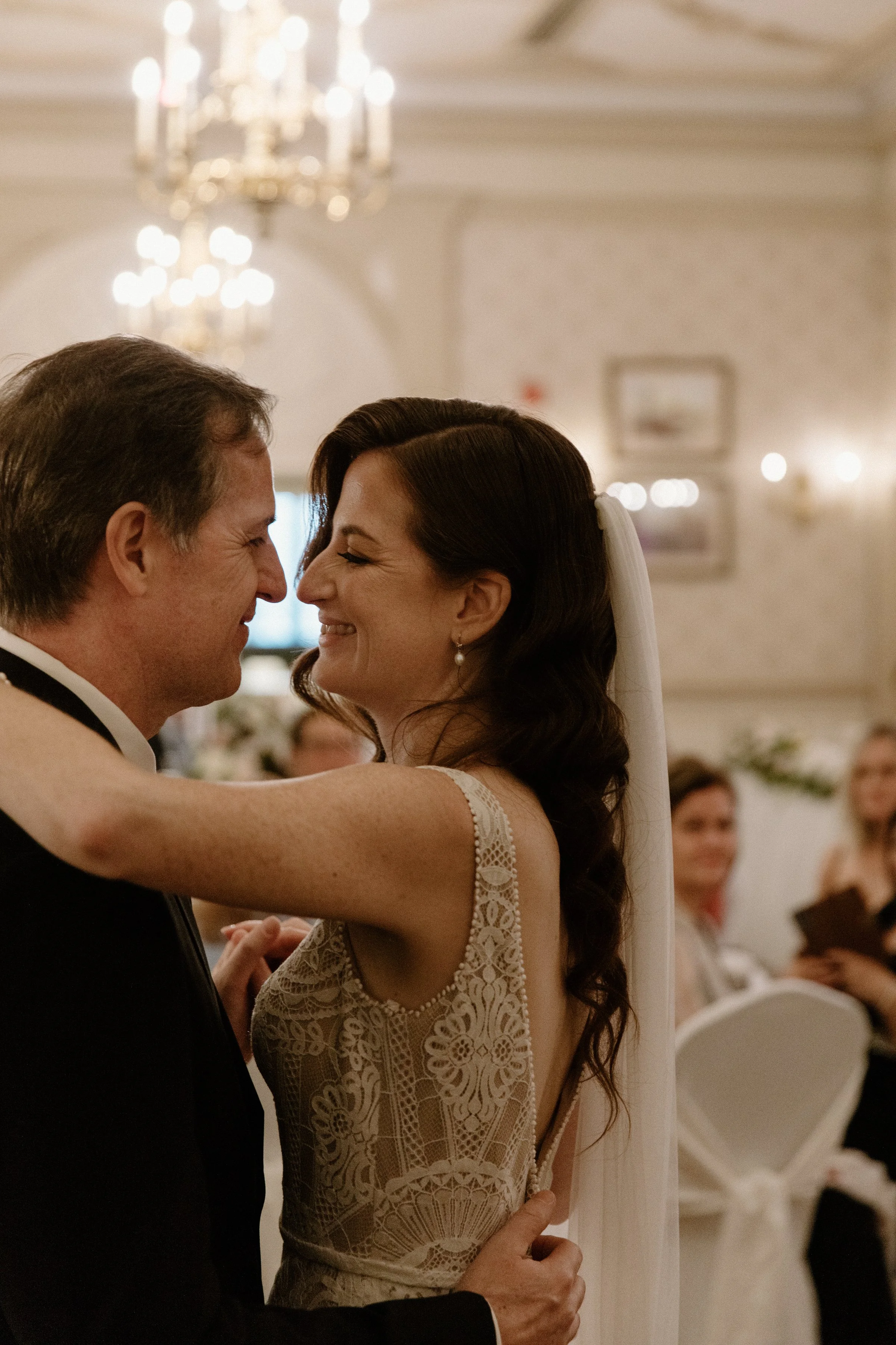 Close up portrait of a bride and groom smiling at each other during their first dance at their Toronto wedding reception