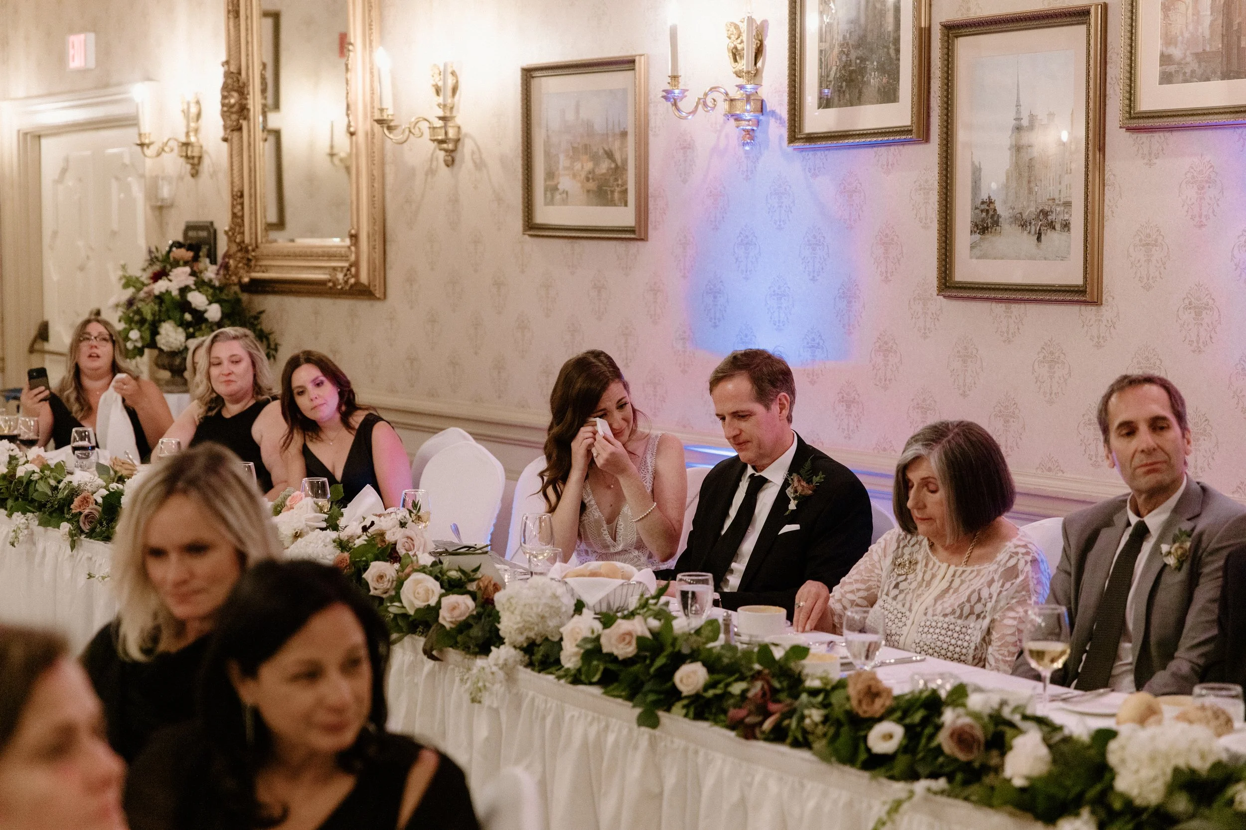 Candid close up of a bride and groom getting emotional while listening to a speech at their Toronto wedding reception