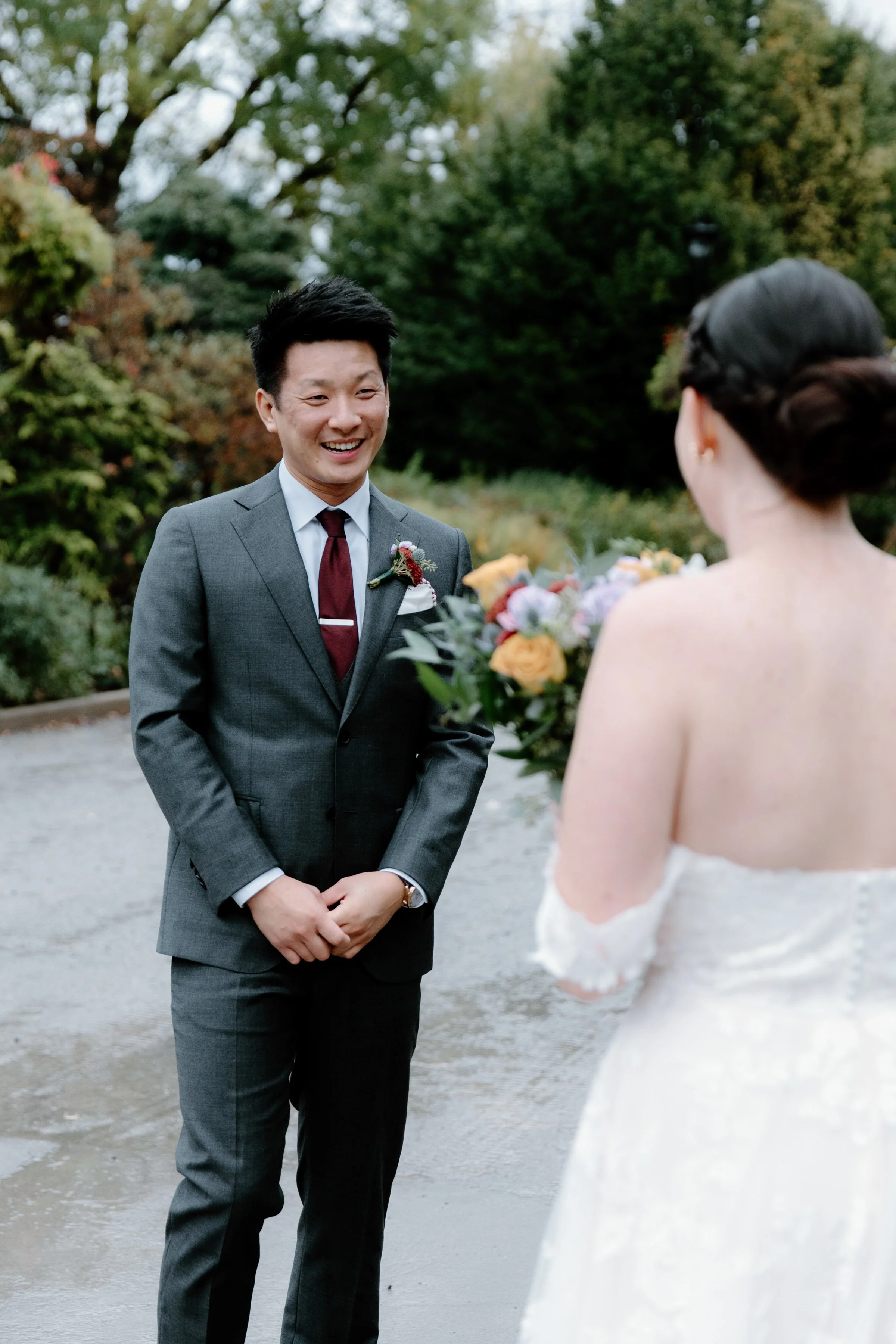 Candid first look moment between bride and groom at Gage Park, Hamilton, Ontario
