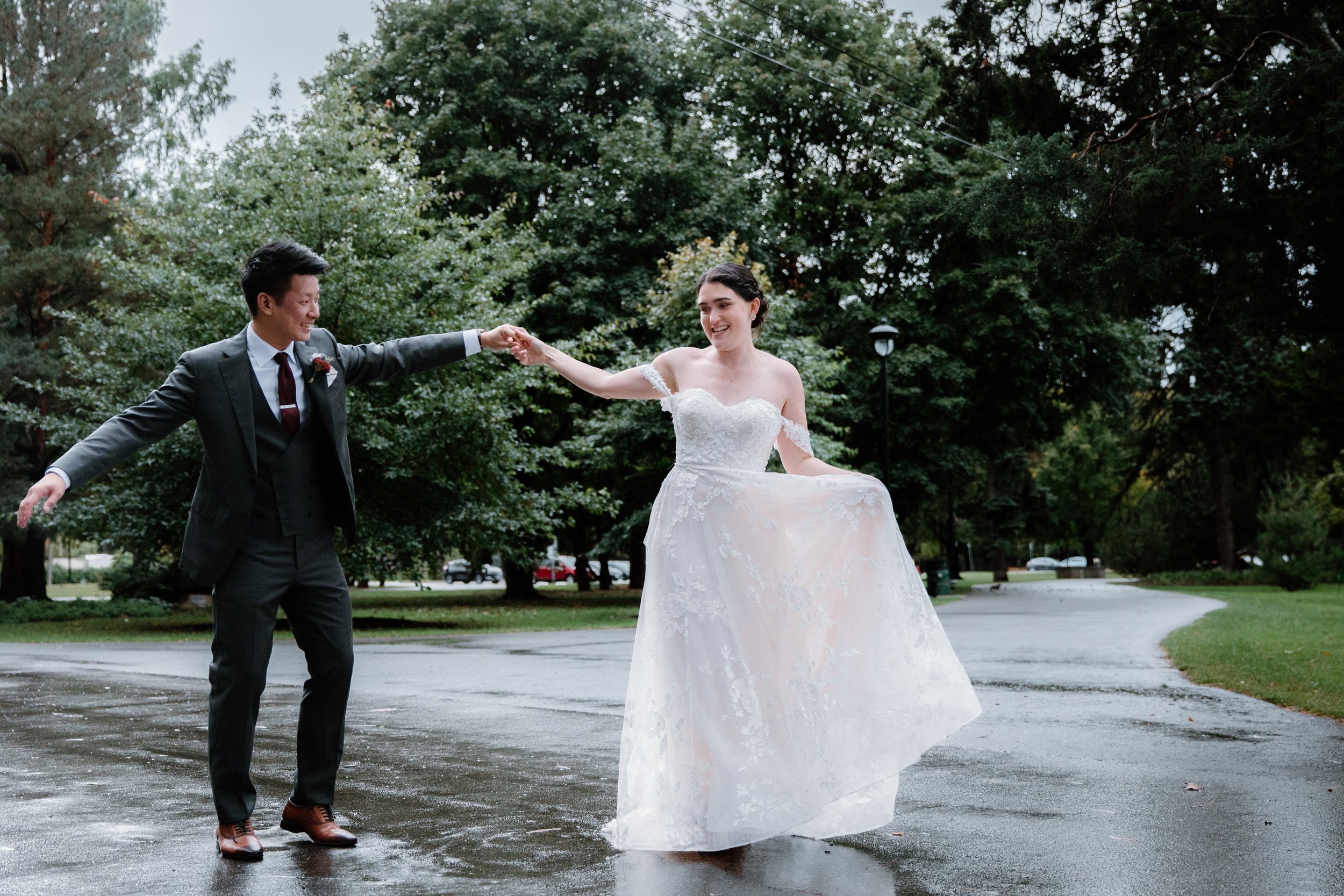 Bride and groom portrait in the rain at Gage Park during their documentary-style Hamilton wedding