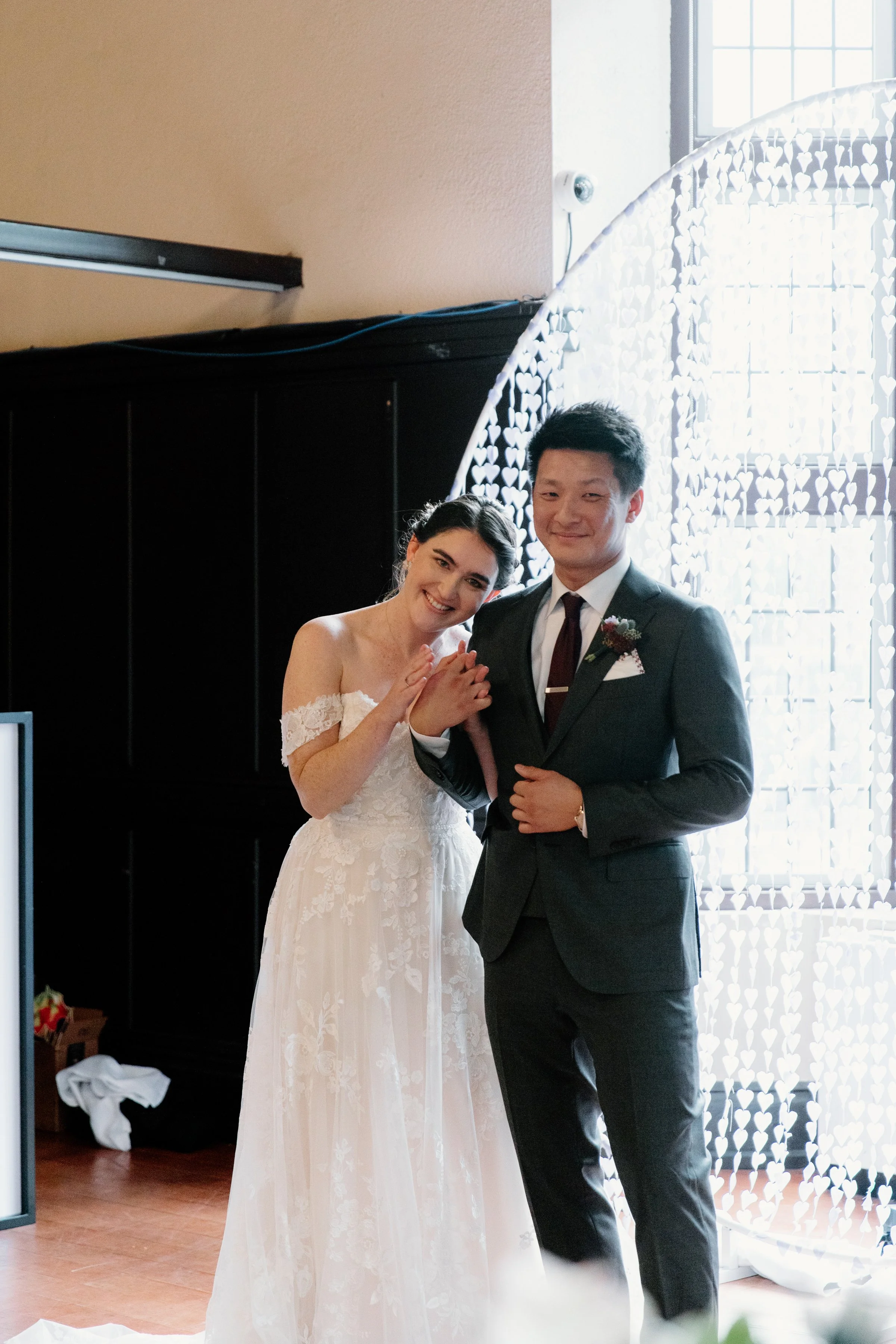 Candid photo of bride and groom laughing and smiling together during their wedding ceremony at the Phoenix Crafthouse, Hamilton
