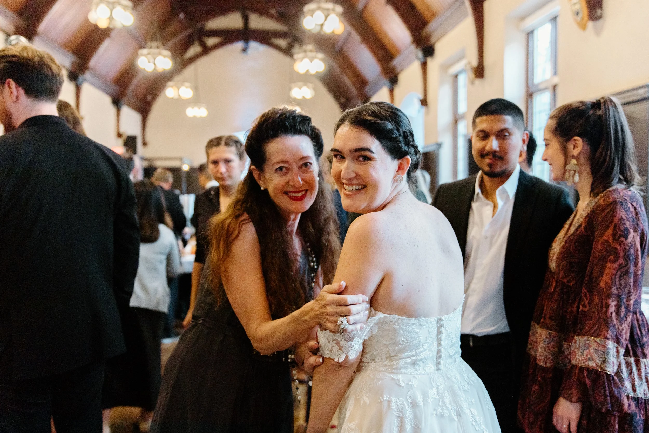 Candid photo of wedding guests celebrating after the ceremony at the Phoenix Crafthouse, McMaster University