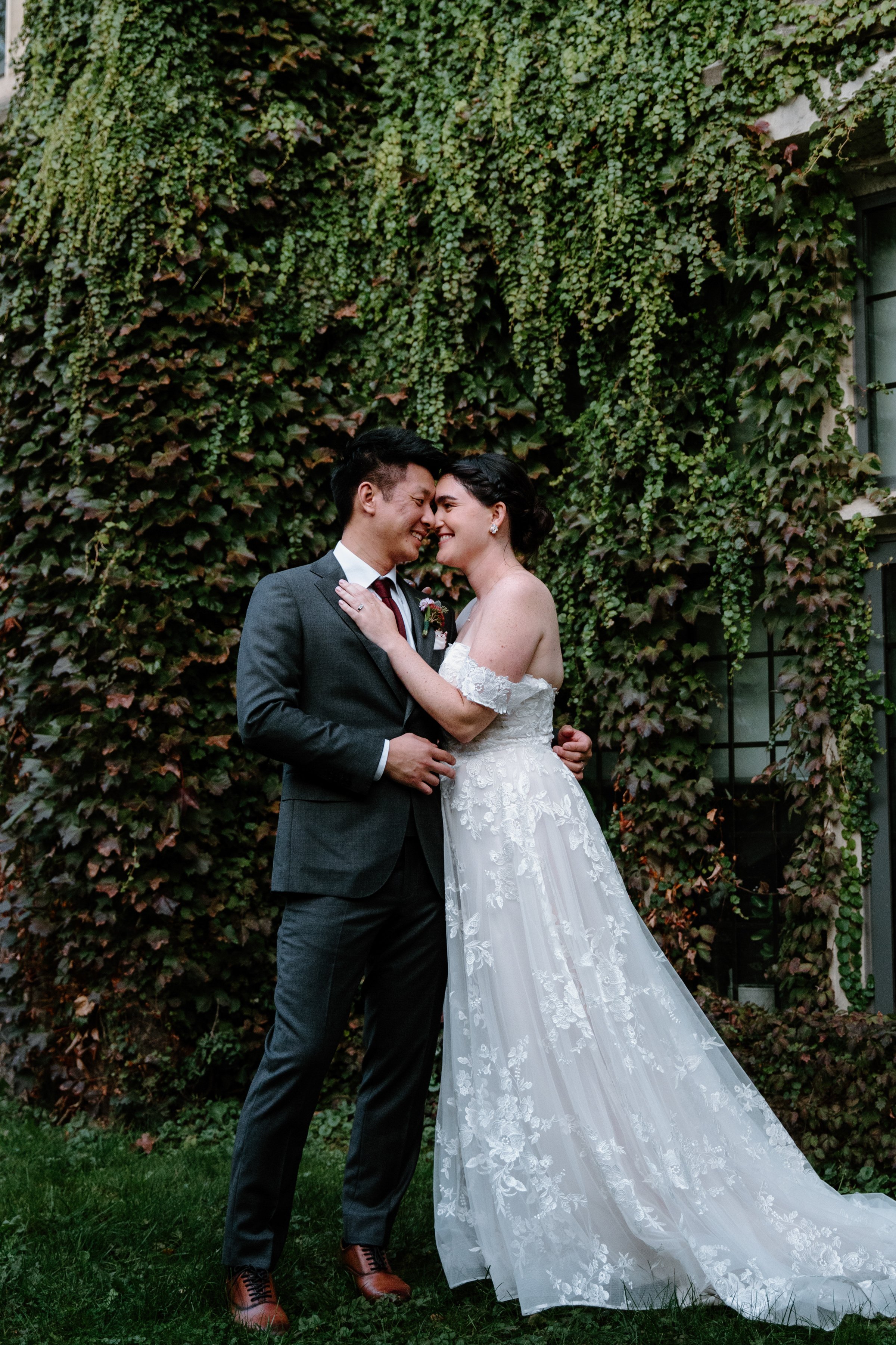 Bride and groom portrait in front of an ivy-covered wall outside the Phoenix Crafthouse, McMaster University, Hamilton