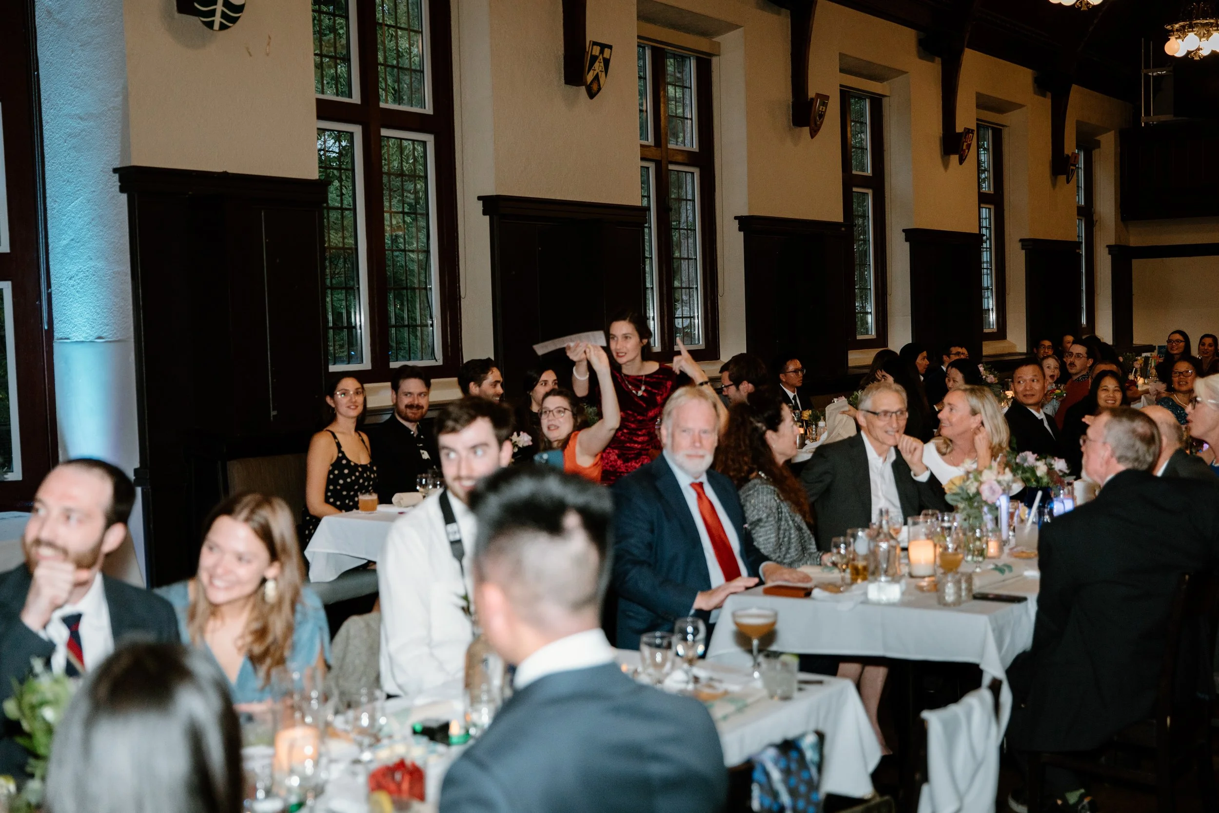Candid photo of wedding guests enjoying the reception at the Phoenix Crafthouse pub, McMaster University