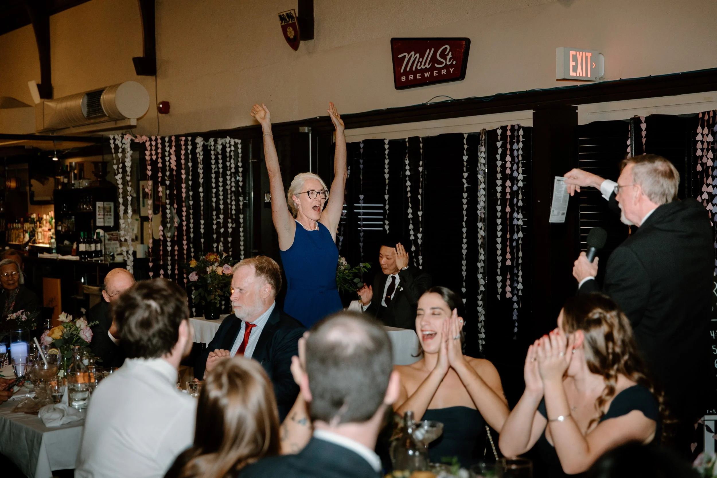 Documentary style photo of guests at a unique wedding reception at McMaster University in Hamilton, Ontario