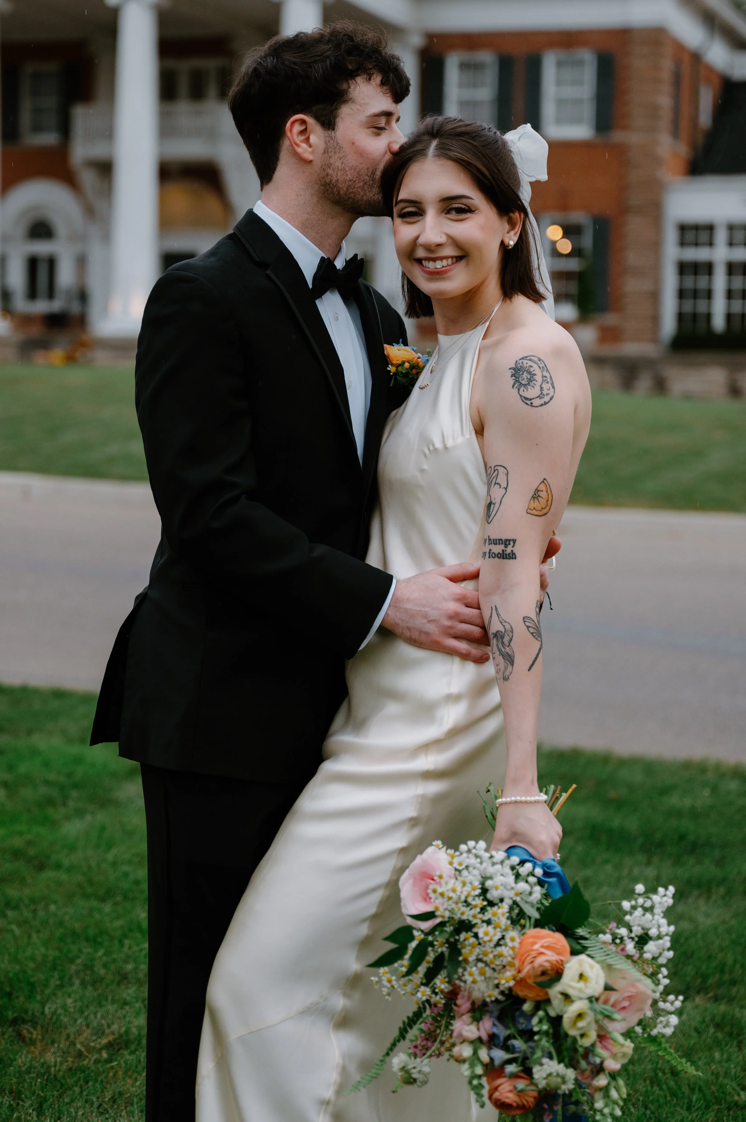 Newlyweds sharing a moment in front of Langdon Hall Country House Hotel, Cambridge Ontario