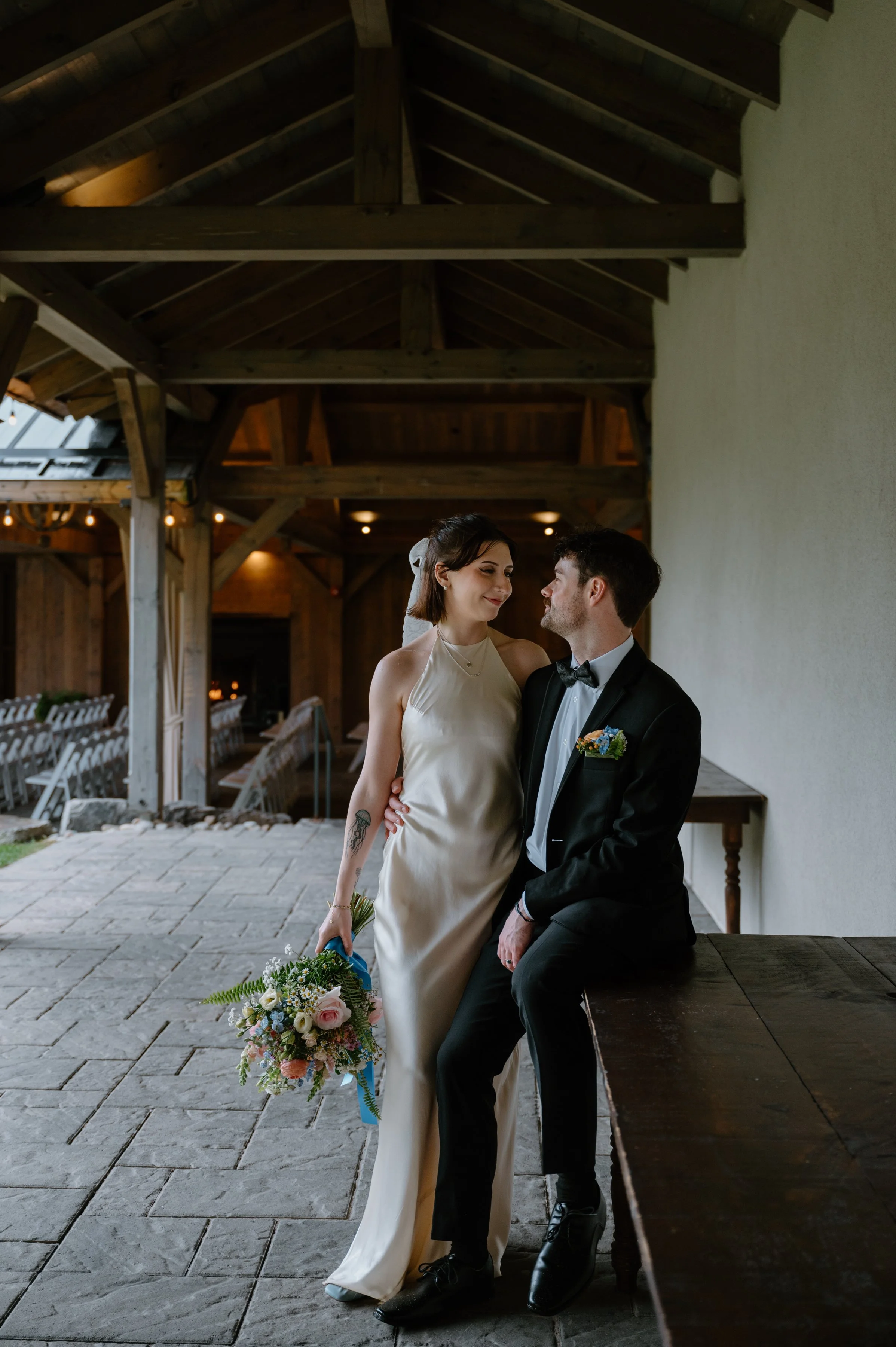 Bride and groom looking at each other romantically inside a rustic farmhouse at Langdon Hall