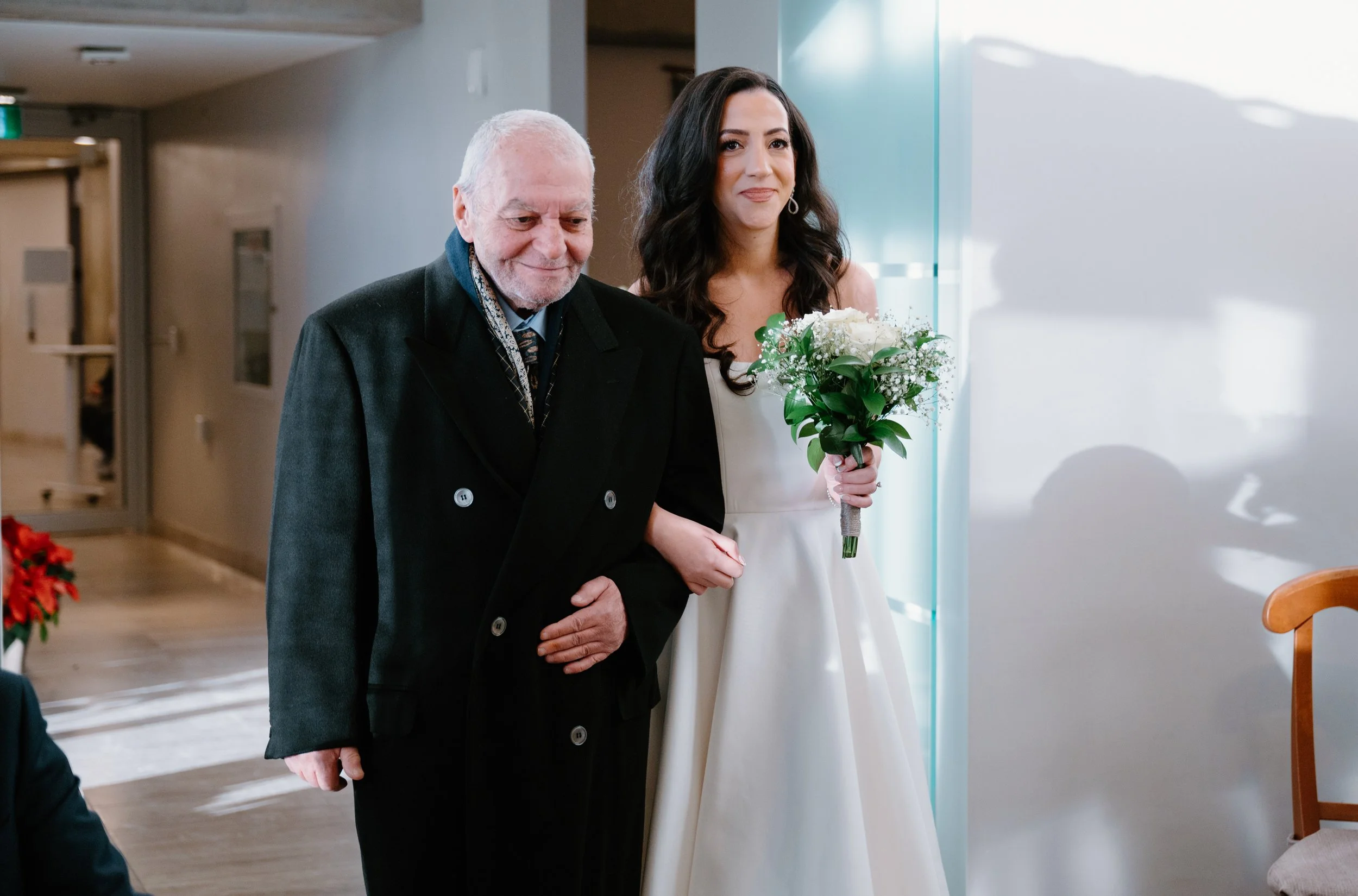 Bride walking down the aisle with her father during a Toronto City Hall elopement
