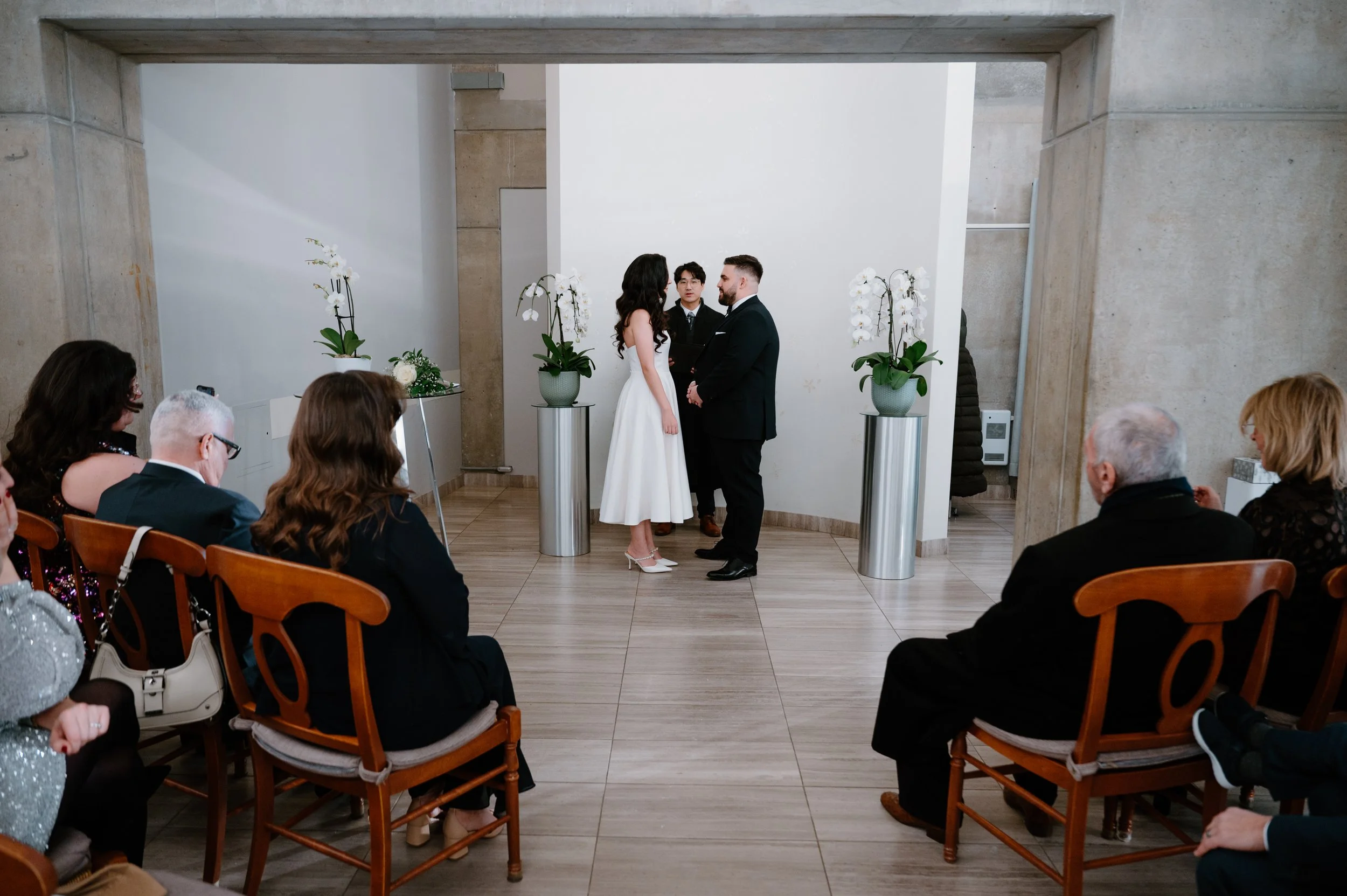 Wide view of a winter elopement ceremony inside Toronto City Hall