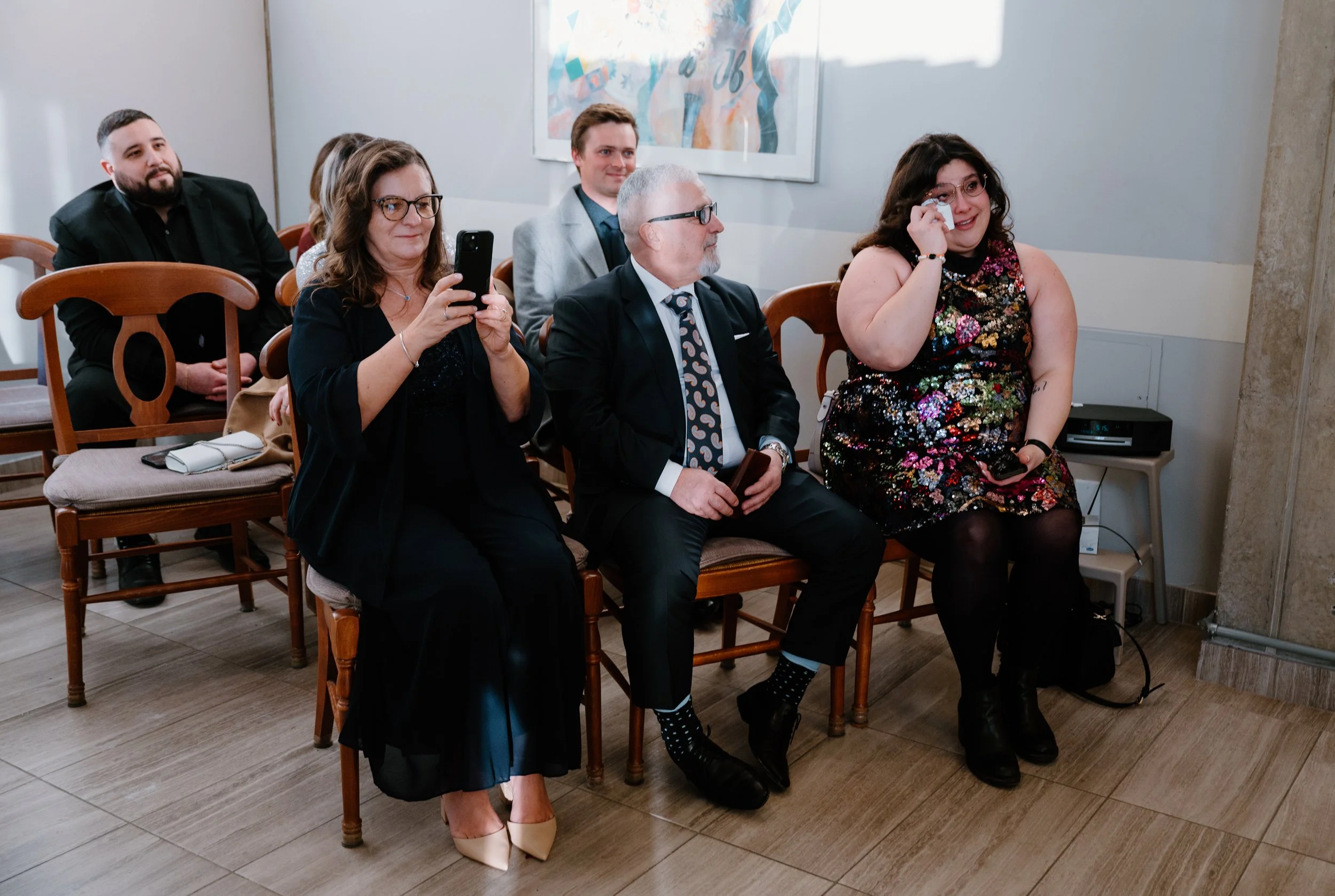 Emotional guest crying during a winter elopement ceremony at Toronto City Hall