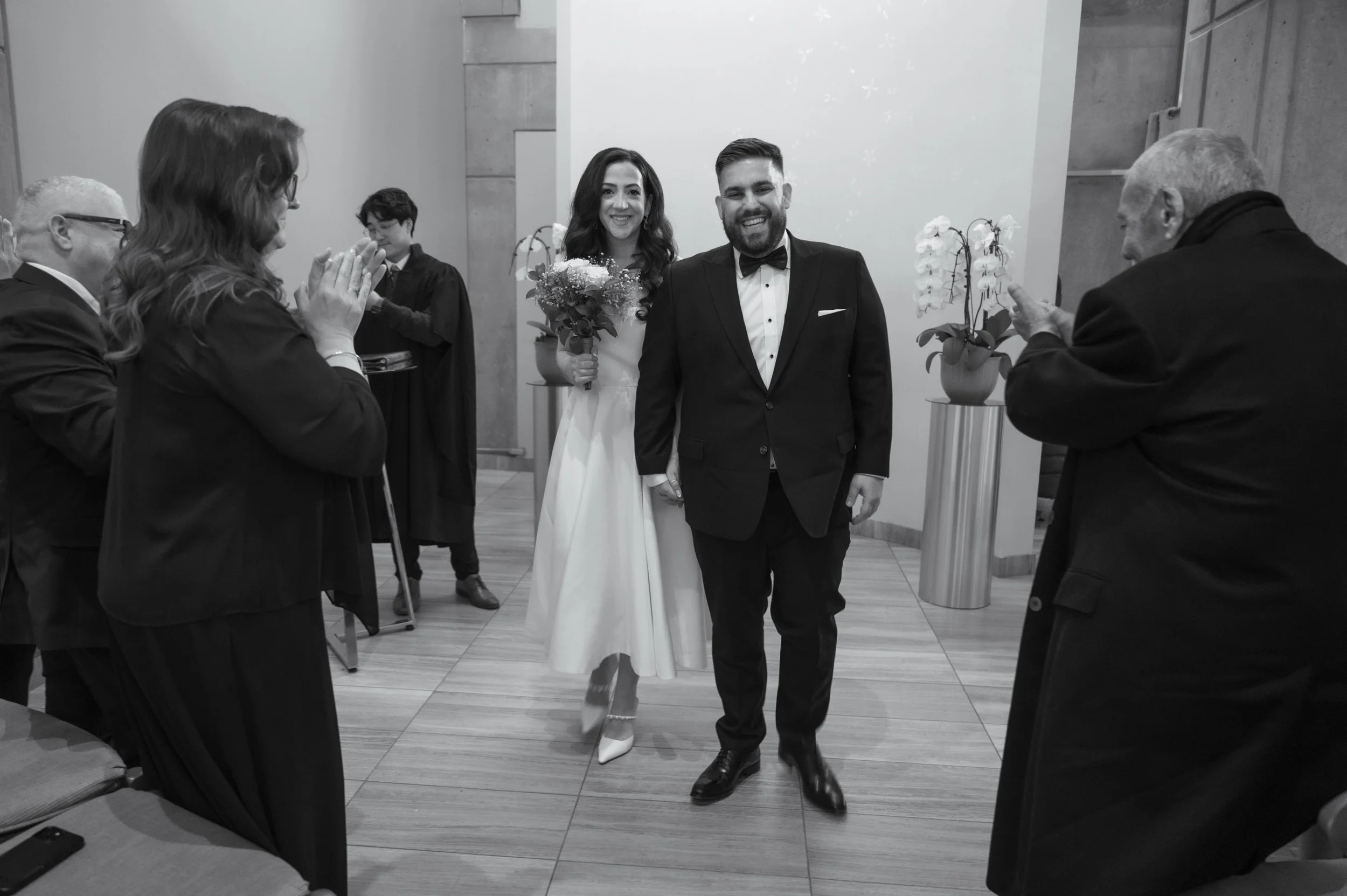 Black and white candid wedding photography of Toronto City Hall elopement