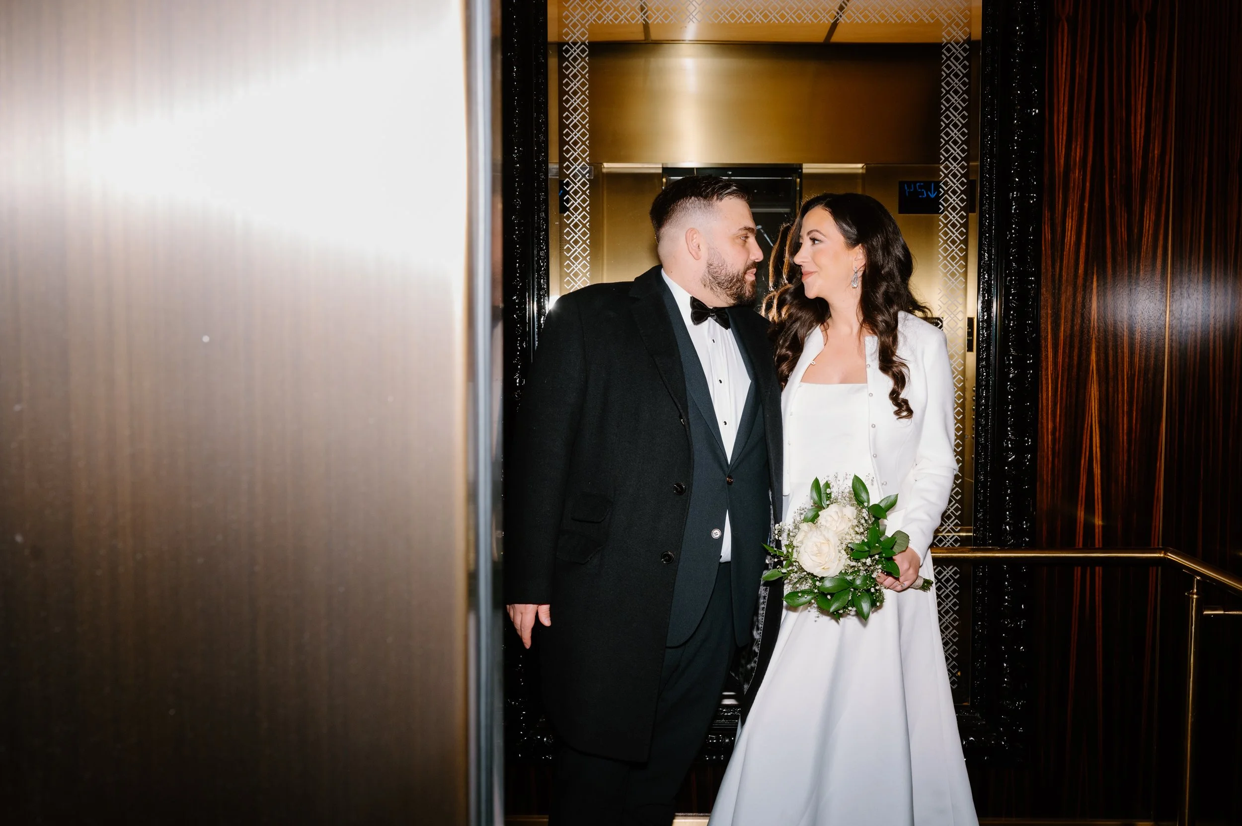 Editorial flash portrait of an eloping couple inside a hotel elevator in Toronto