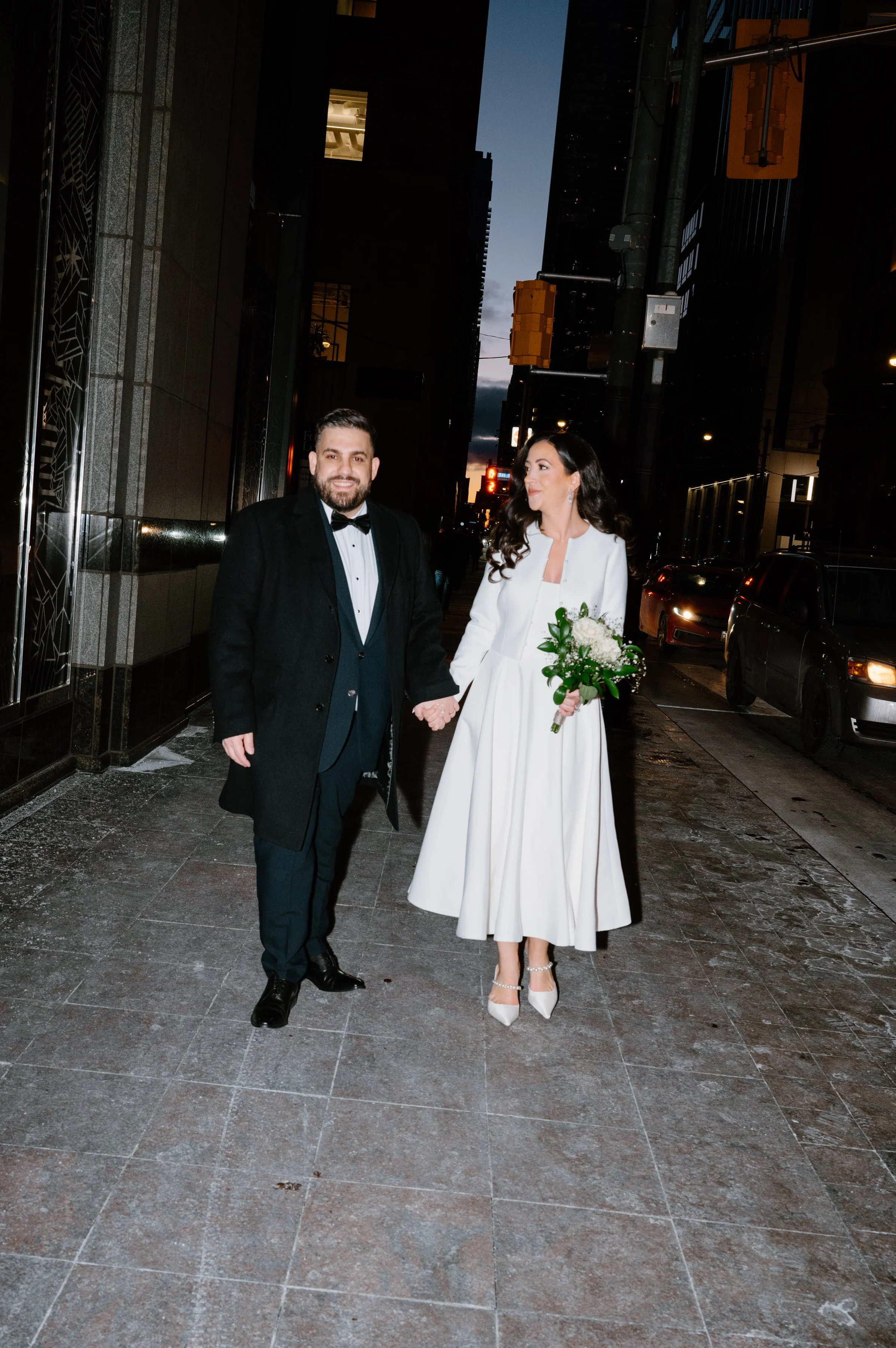 Editorial flash portrait of a couple outside the St. Regis Hotel in downtown Toronto