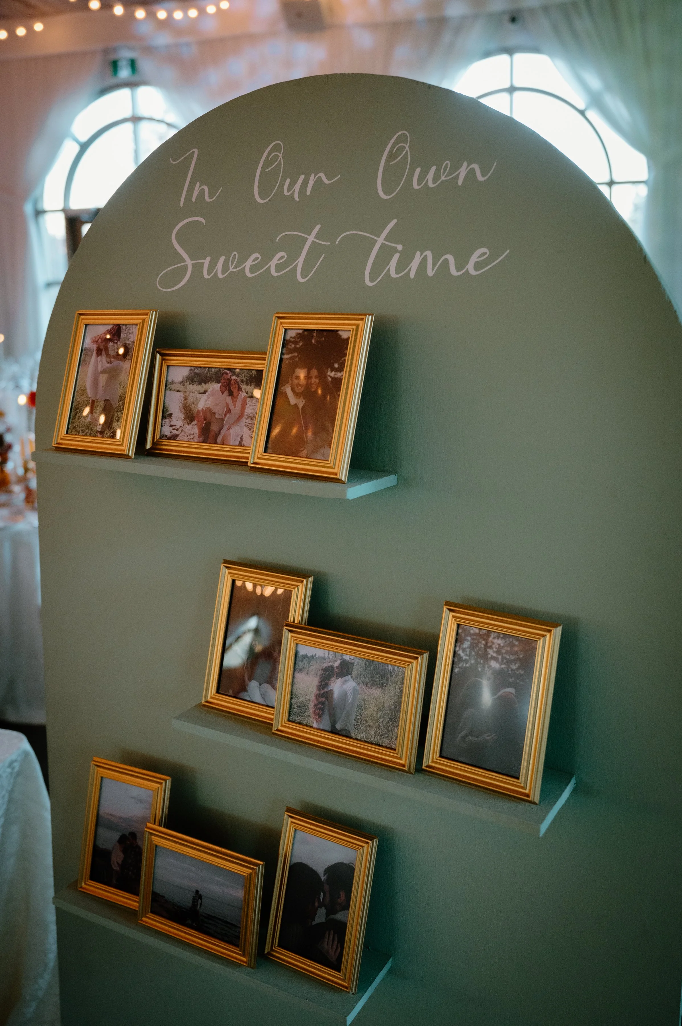 Detail photo of a reception decor wall featuring photos of the couple through the years at their Caledon wedding