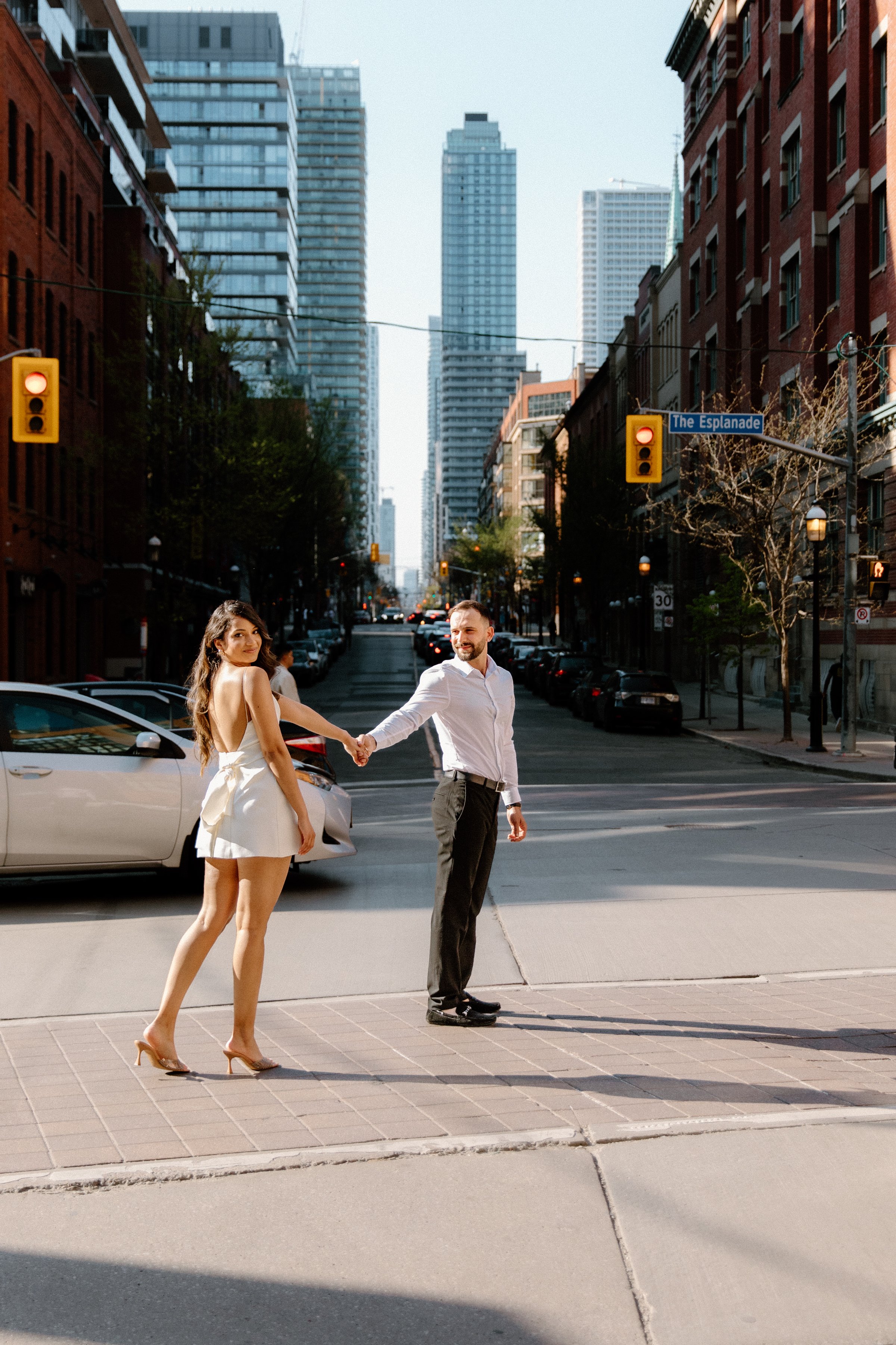 Engaged couple posing near St. Lawrence Market during a Toronto city engagement session