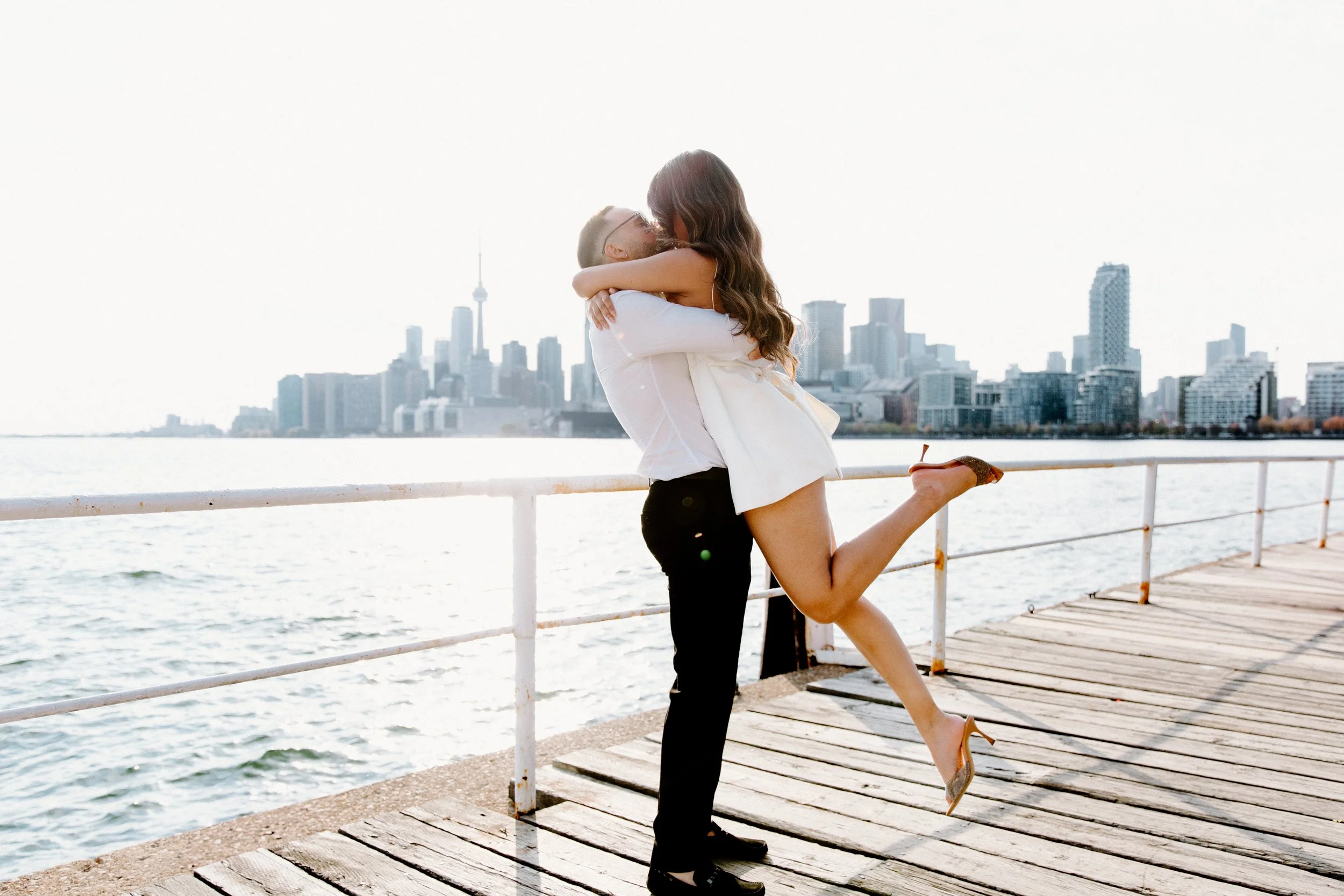Engagement photos at Polson Pier with the Toronto skyline in the background