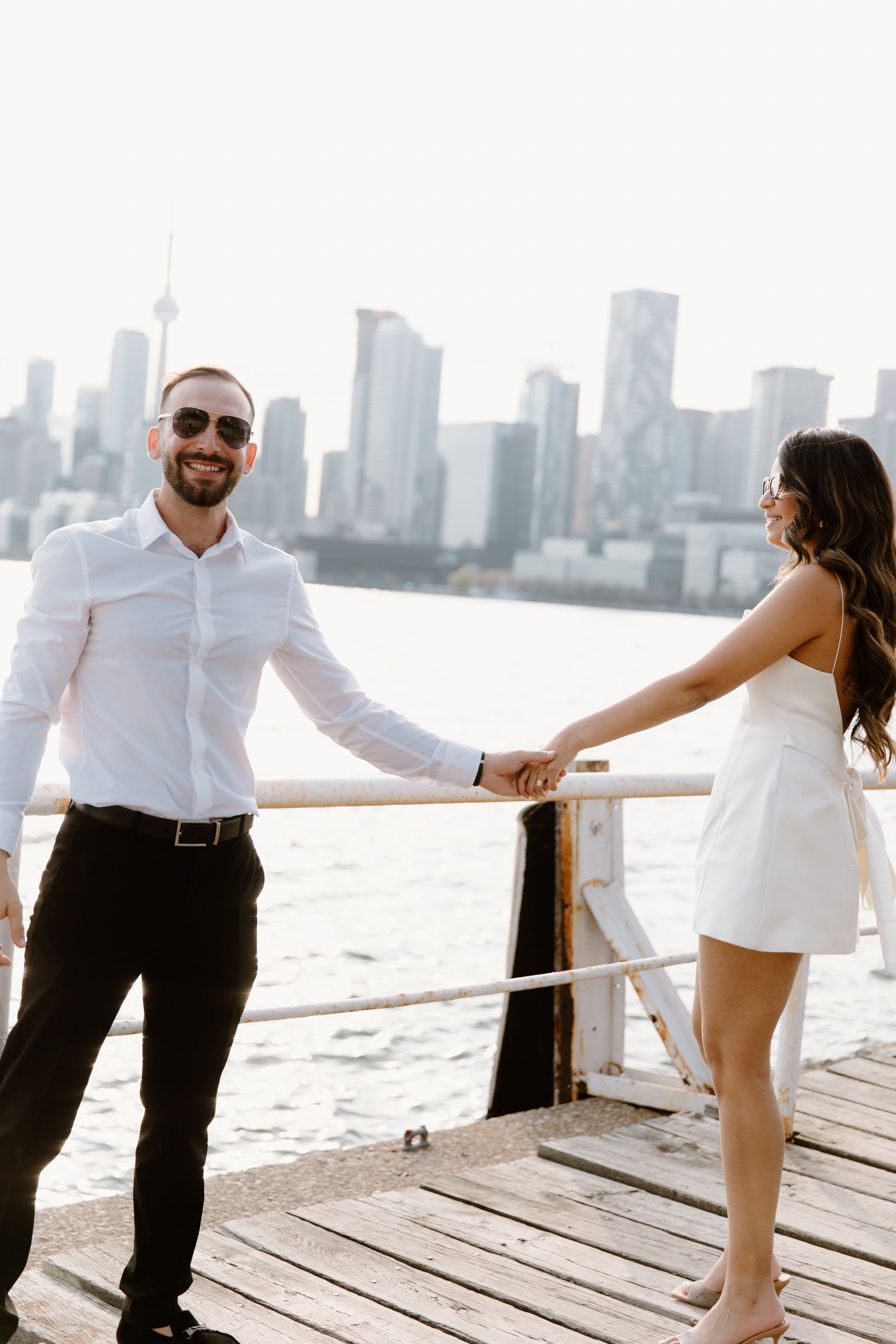 Engagement session moving from city streets to the Toronto waterfront