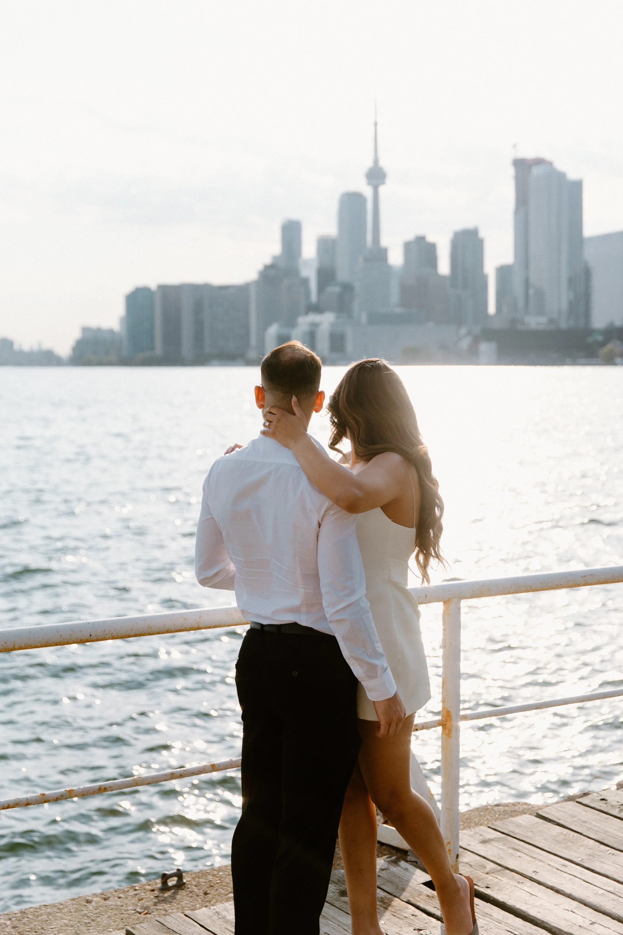 Engagement photo of a couple at sunset in Downtown Toronto with the CN Tower in the background